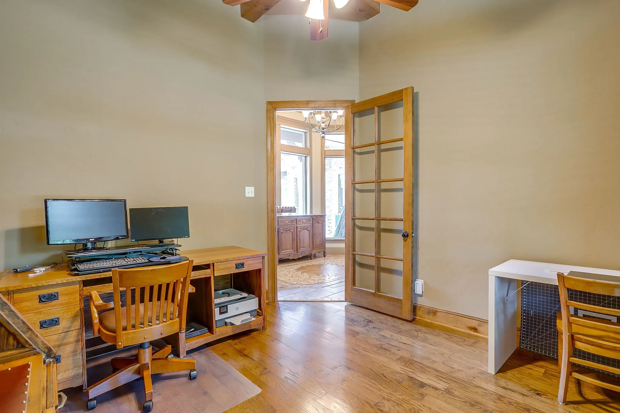 Room featuring wood-finish flooring, a ceiling fan, and painted walls