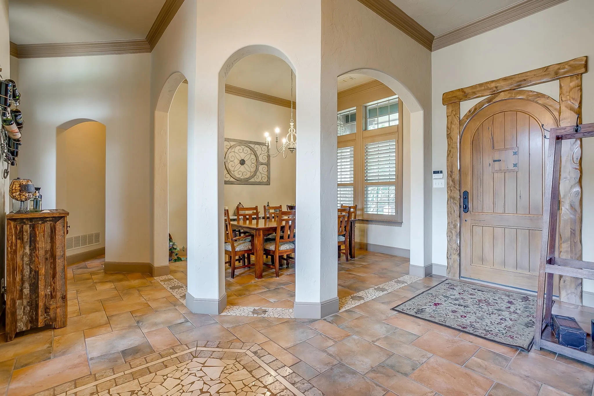 Entry foyer featuring a rustic wood front door within a decorative timber frame