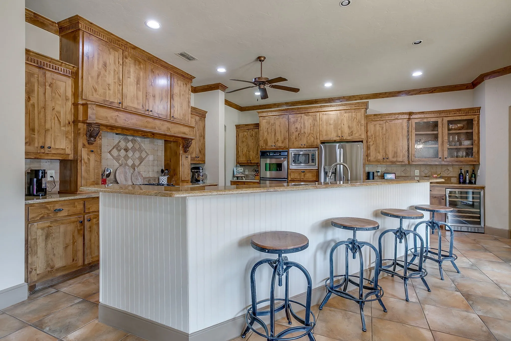 Spacious kitchen with wood cabinetry and light-toned countertops