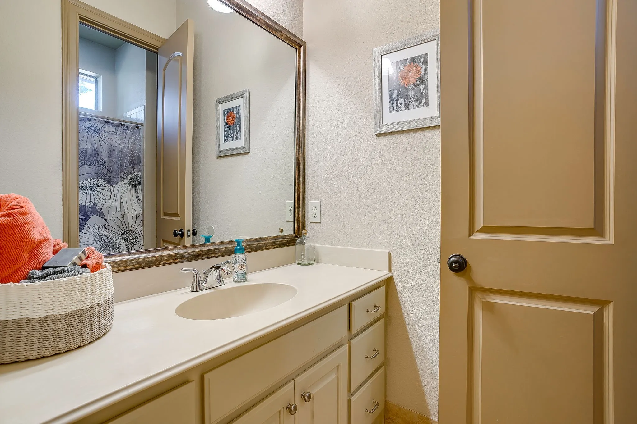 Bathroom vanity featuring an integrated sink, polished chrome faucet, and ample under-counter storage with multiple drawers and cabinet doors