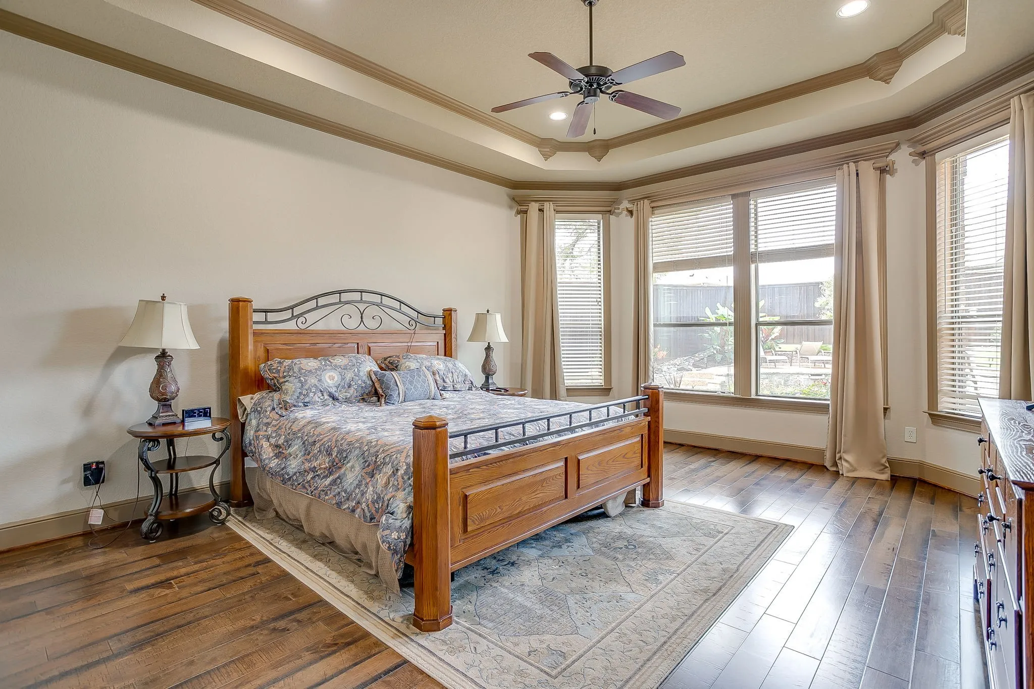Primary Bedroom featuring a tray ceiling with a ceiling fan and recessed lighting