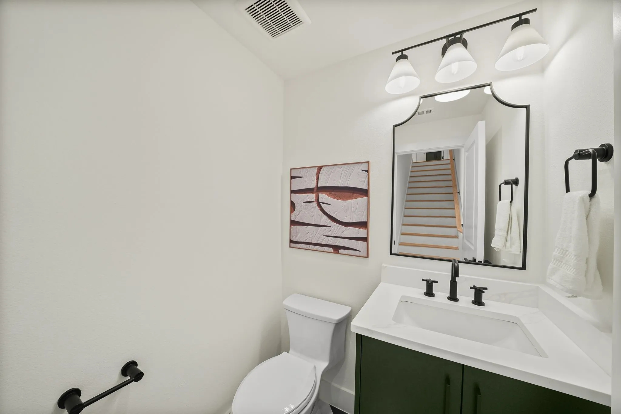 Bathroom featuring a custom green vanity with a white countertop and integrated sink