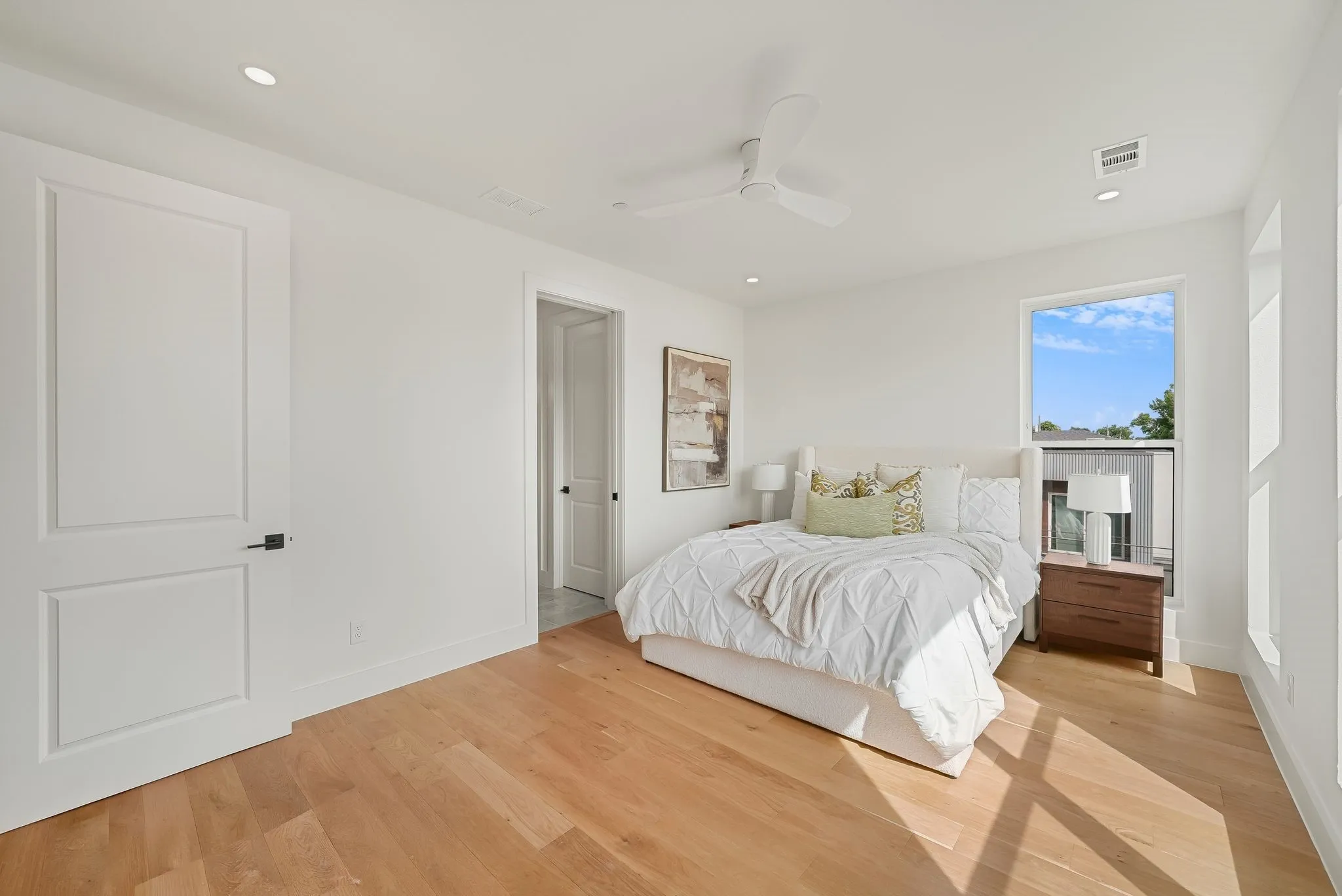 Light wood-finish flooring with white walls