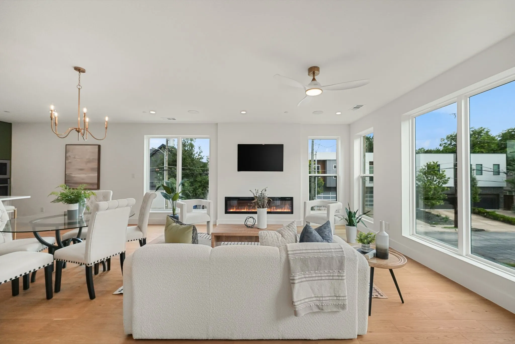 Open-concept living area with light wood-finish flooring