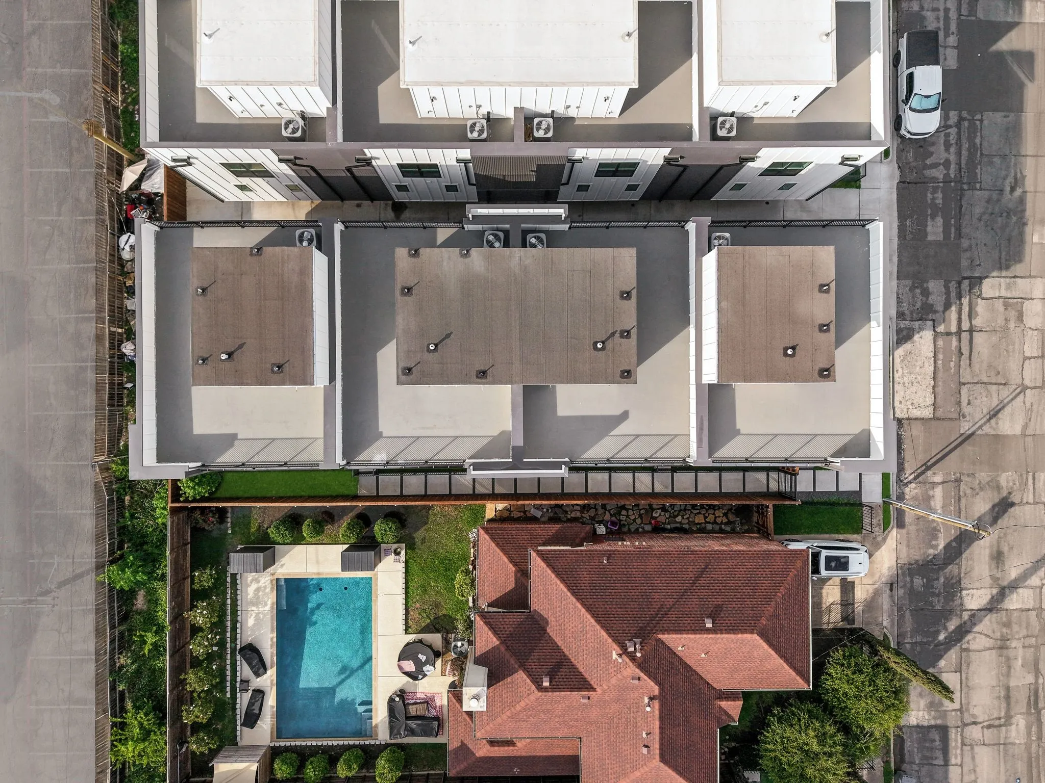 Aerial perspective showcasing a modern multi-unit building with rooftop terraces