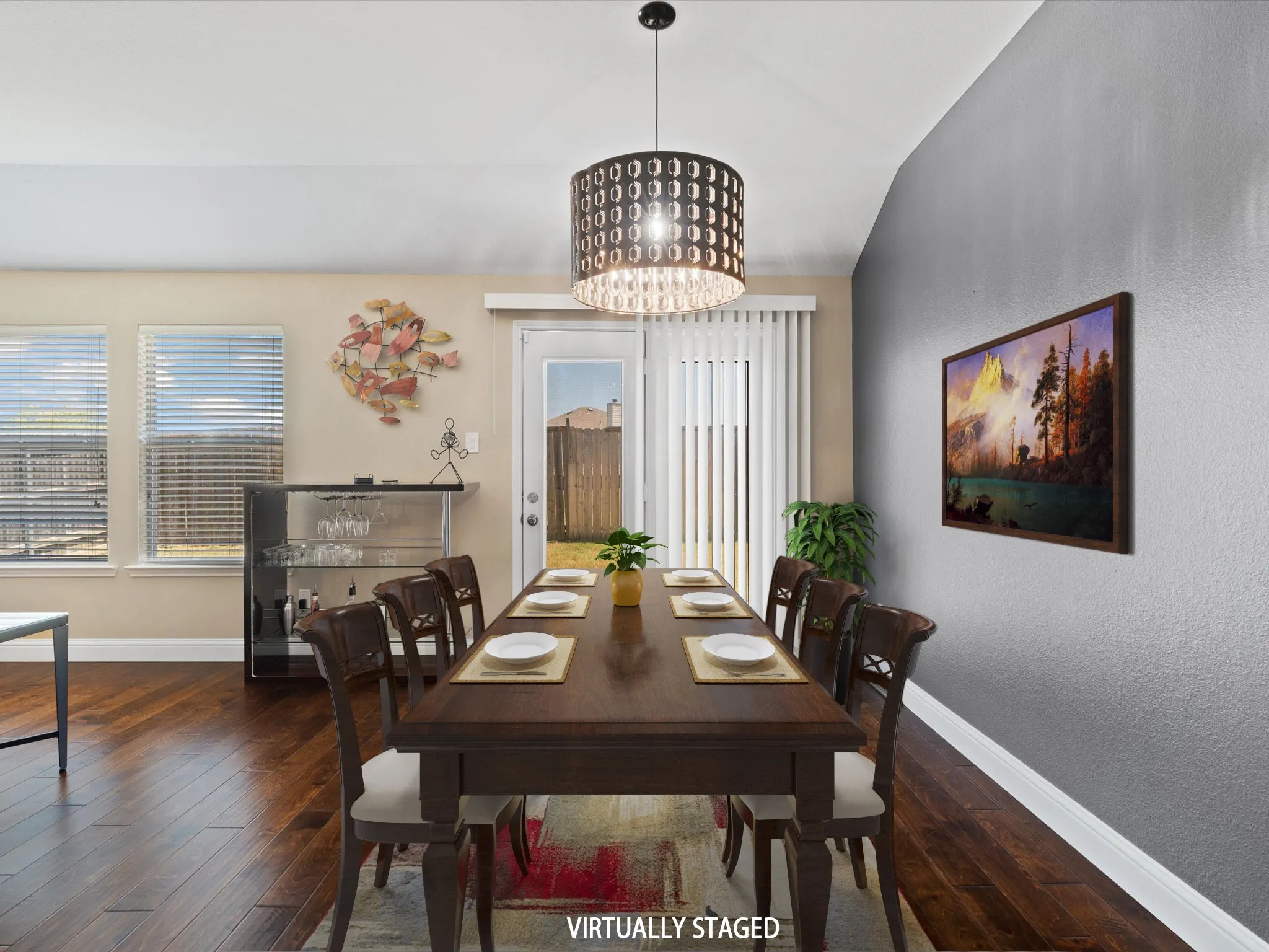 Dining space with a notable chandelier, dark hardwood / wood-style flooring, a healthy amount of sunlight, and vaulted ceiling