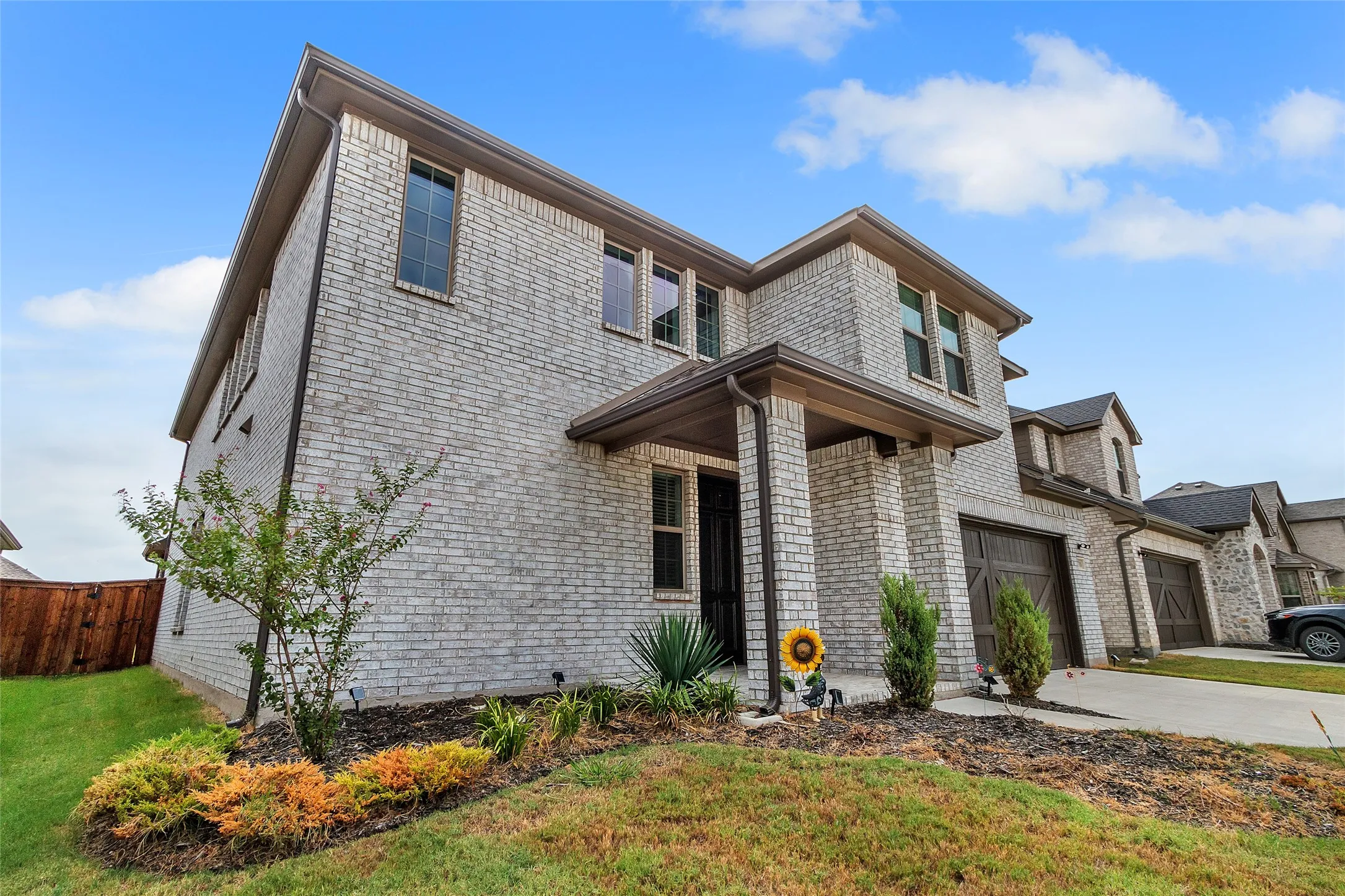 View of front of house with a front yard and a garage
