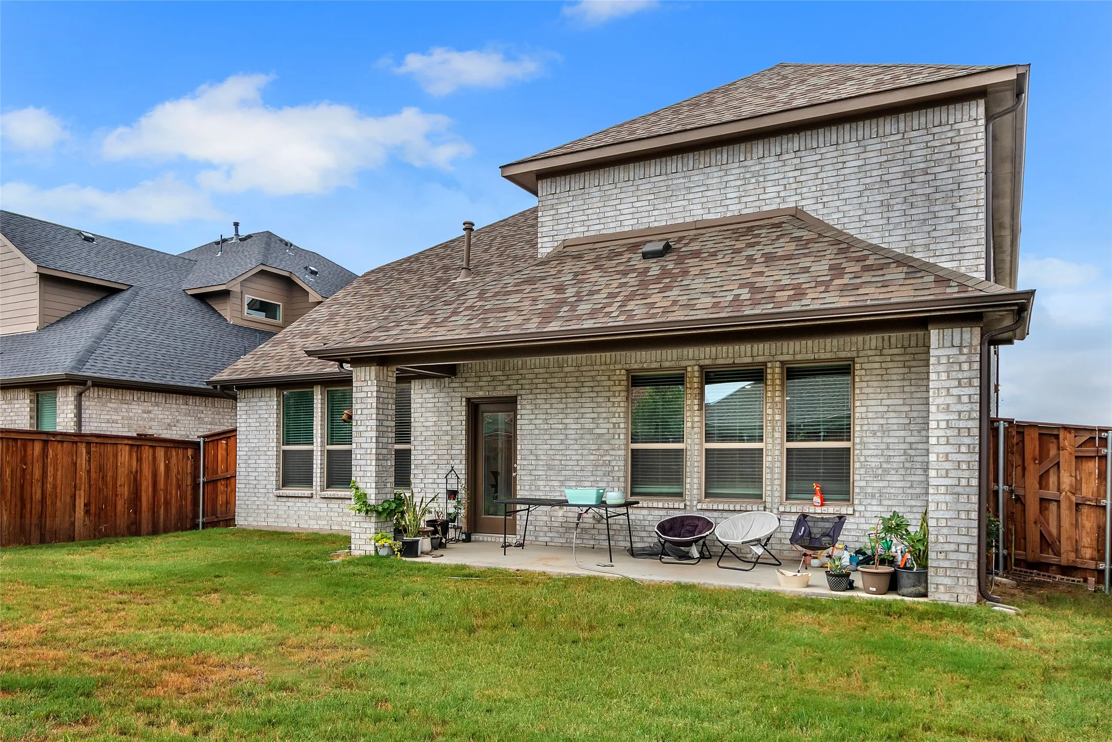 Back of property with a yard and a patio