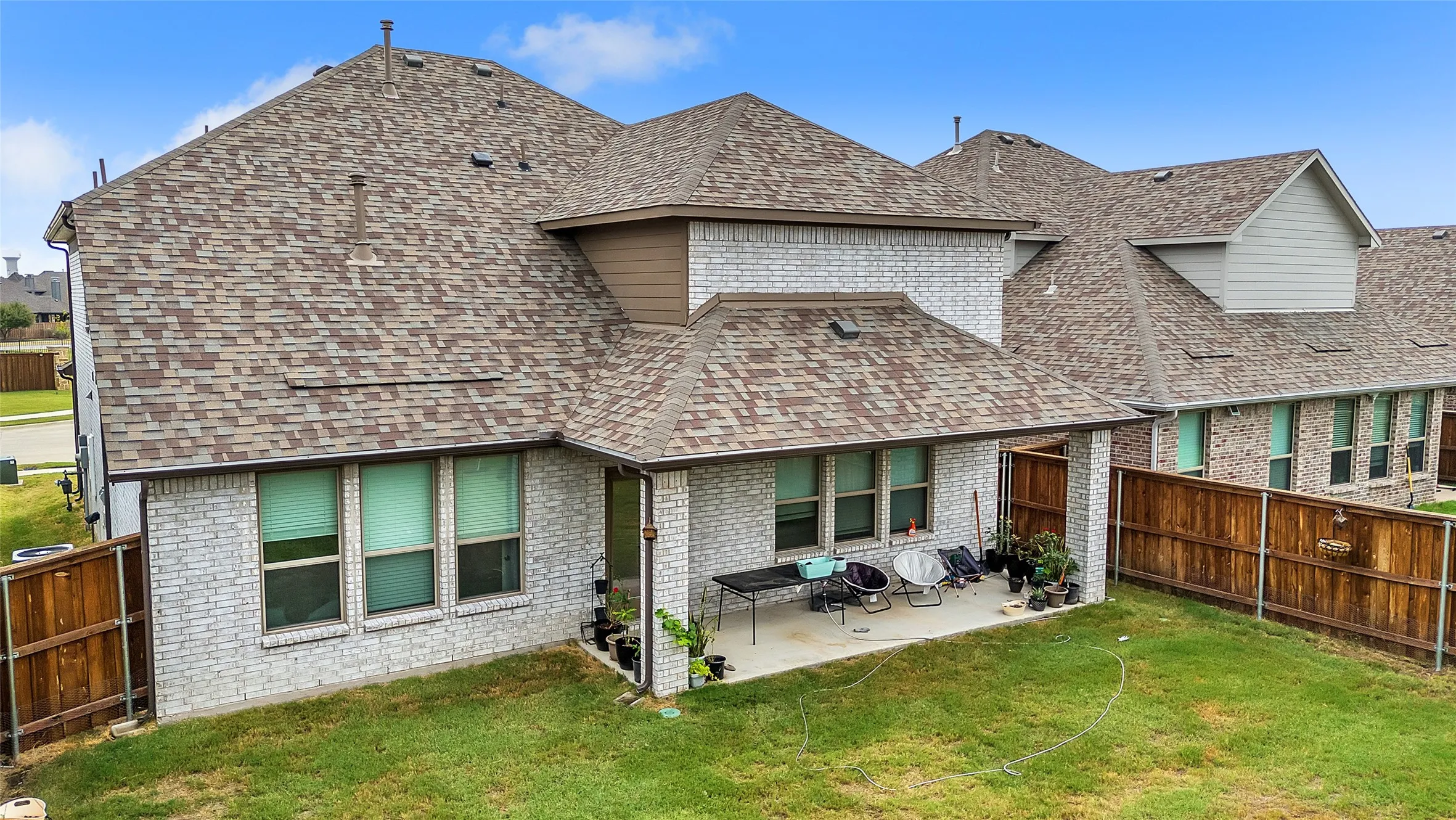 Back of house featuring a yard and a patio area
