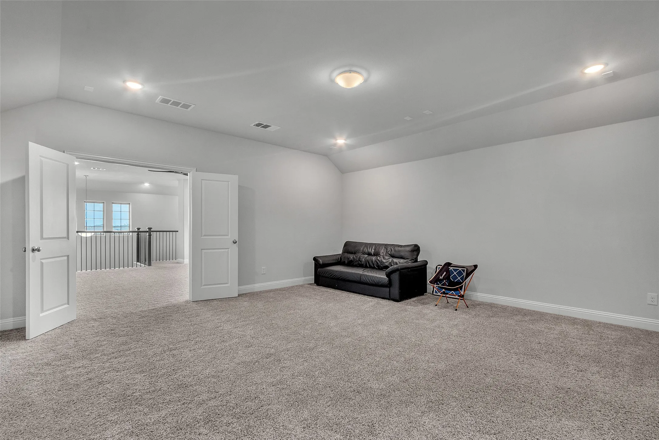 Living area featuring lofted ceiling and light colored carpet