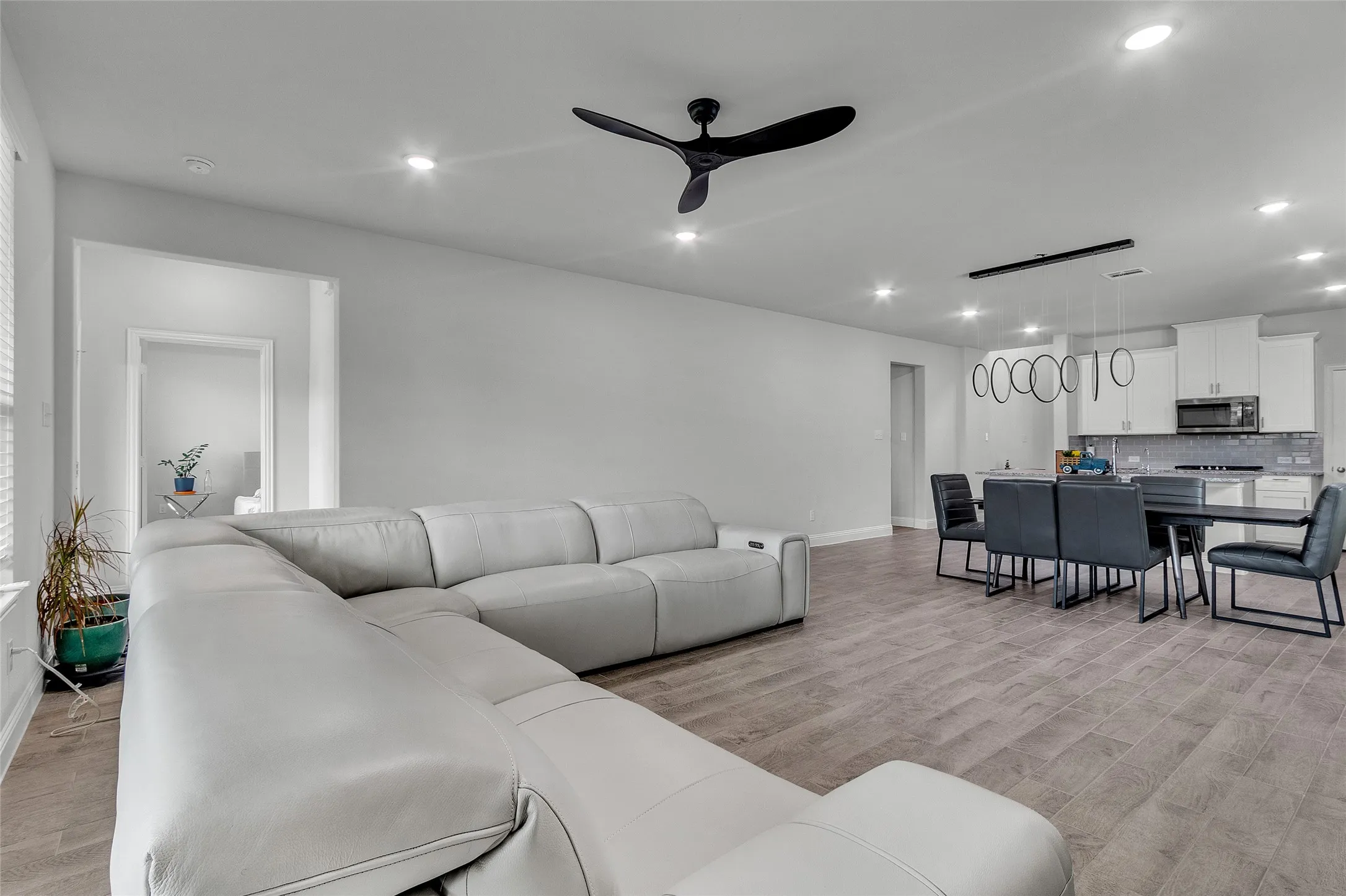 Living room featuring ceiling fan and light wood-type flooring