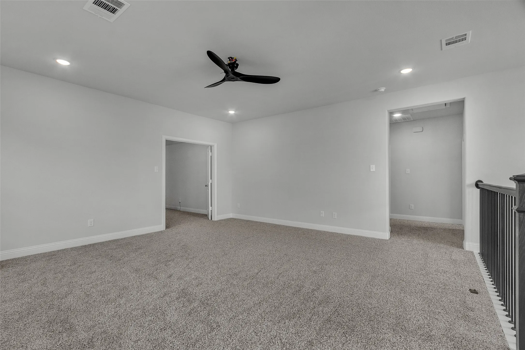 Spare room with ceiling fan and light carpet