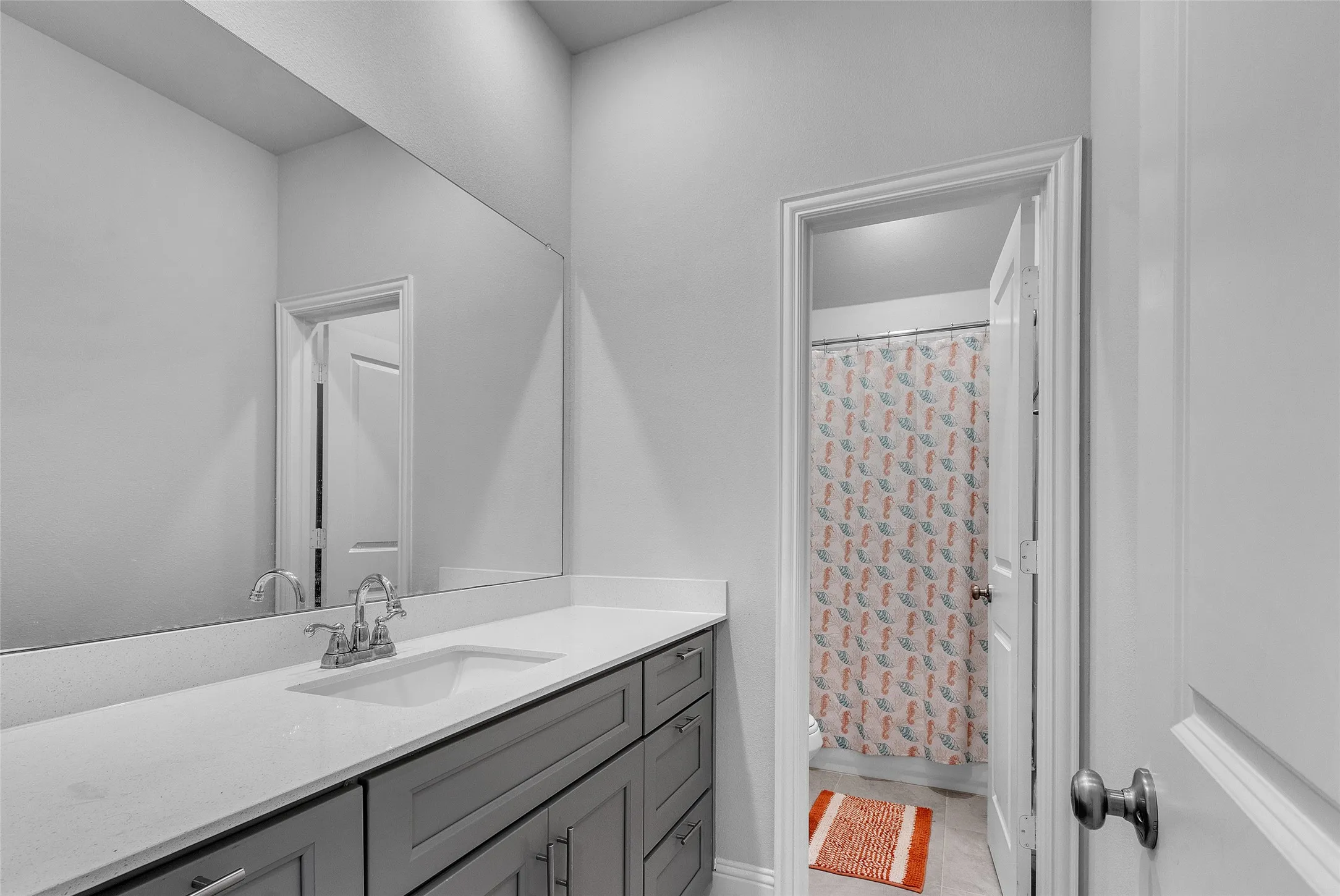 Bathroom featuring vanity, toilet, a shower with curtain, and tile patterned floors