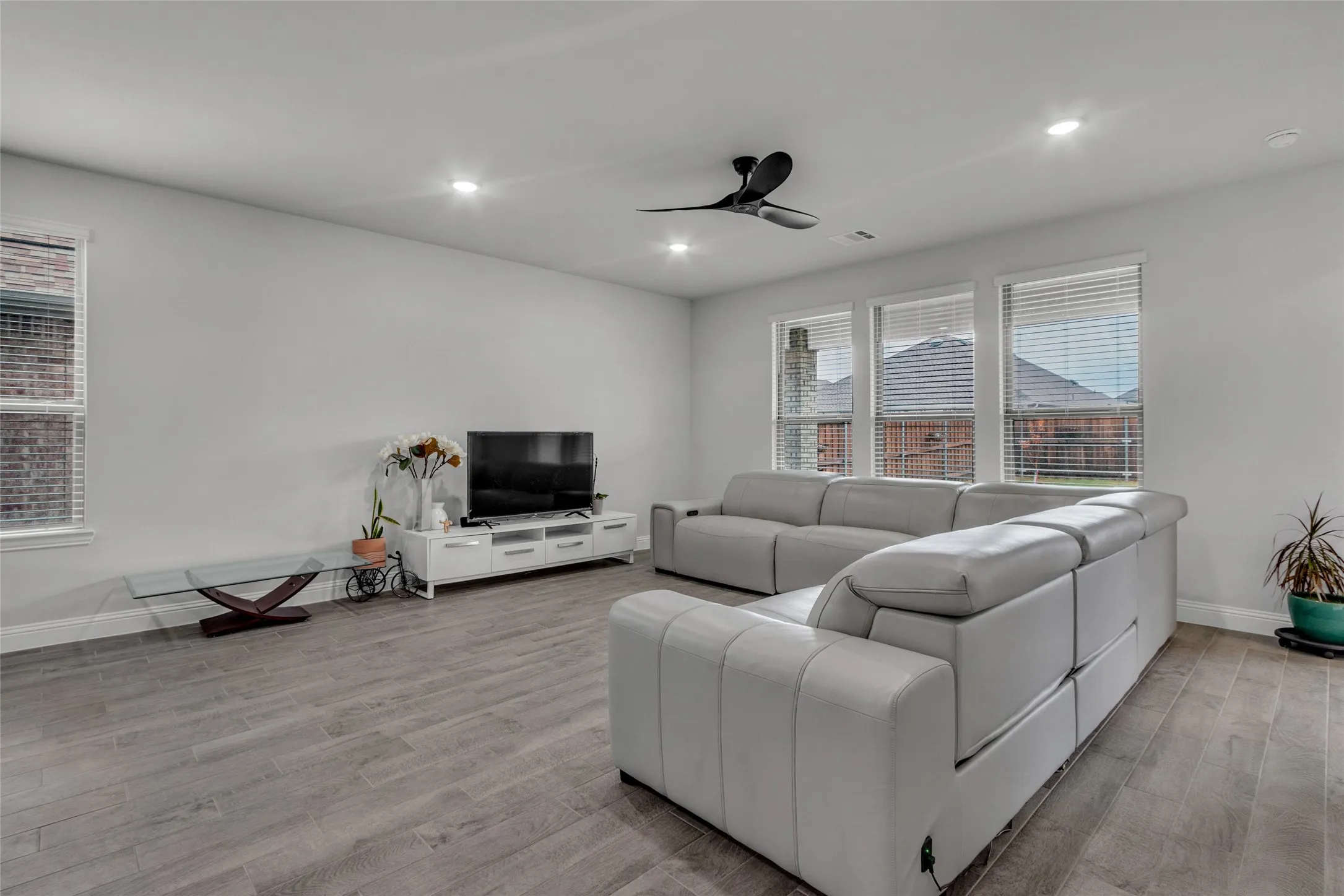Living room featuring light wood-type flooring and ceiling fan