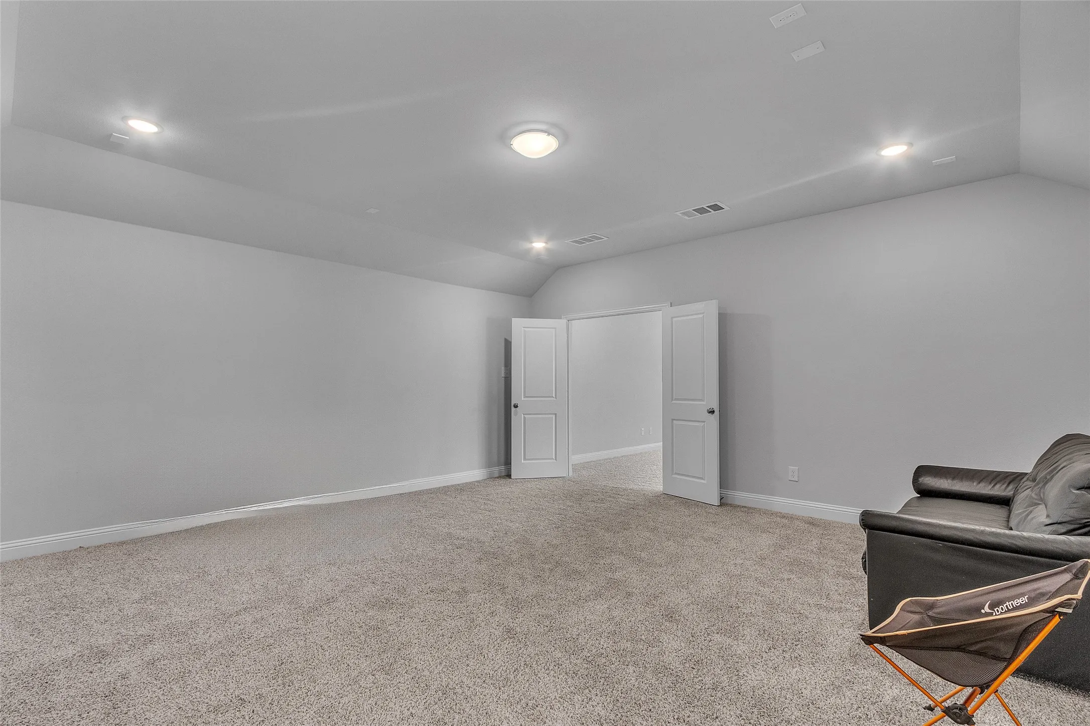 Sitting room featuring lofted ceiling and light colored carpet