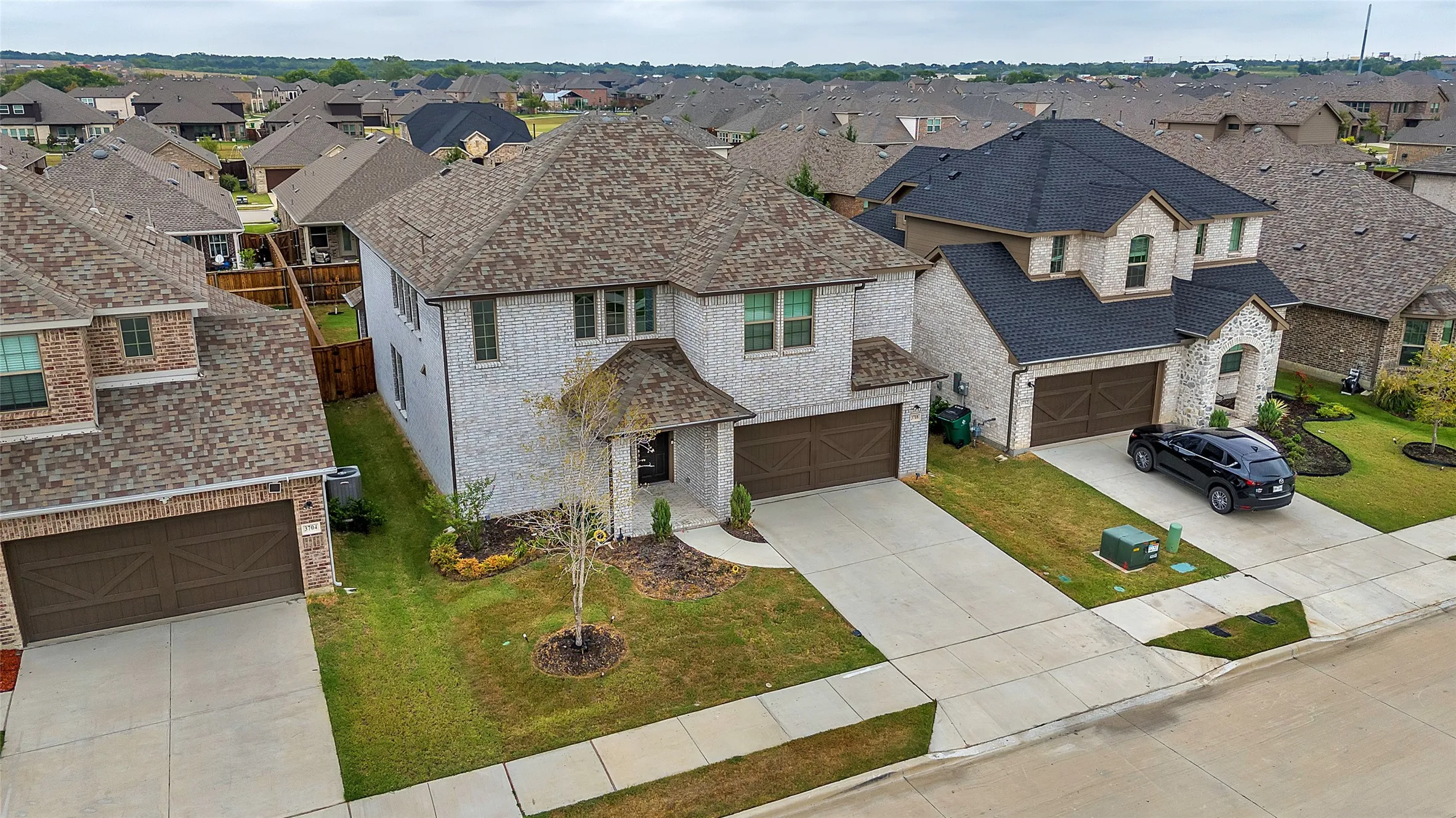 View of front of home with a garage and a front yard