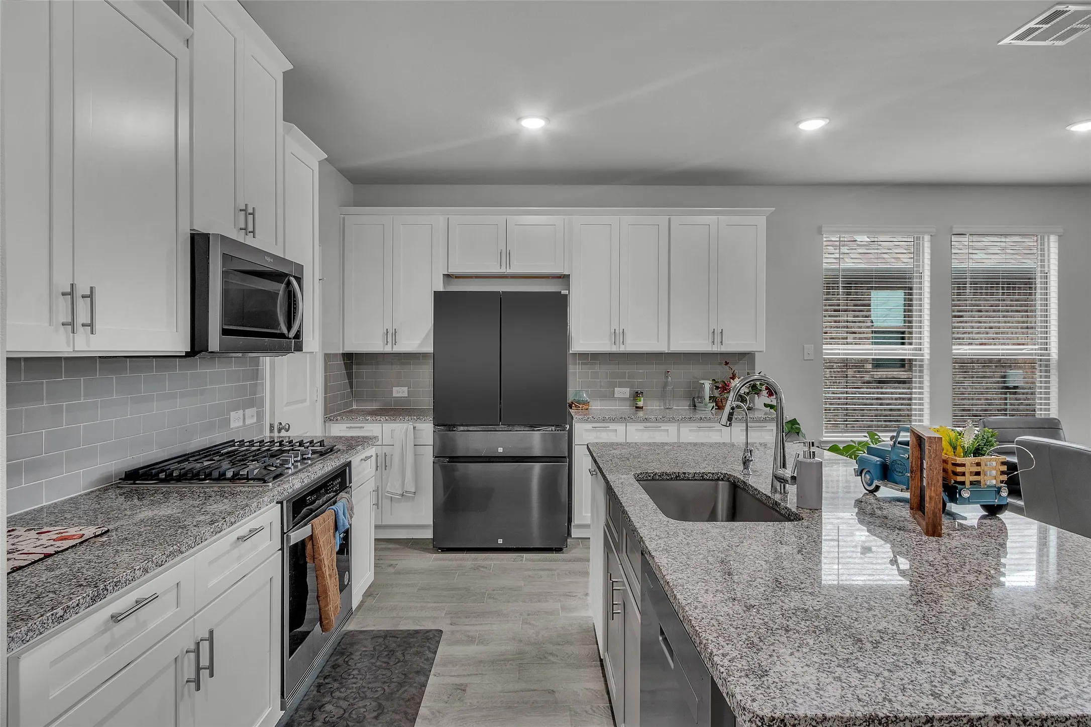 Kitchen featuring a kitchen island with sink, appliances with stainless steel finishes, plenty of natural light, and sink