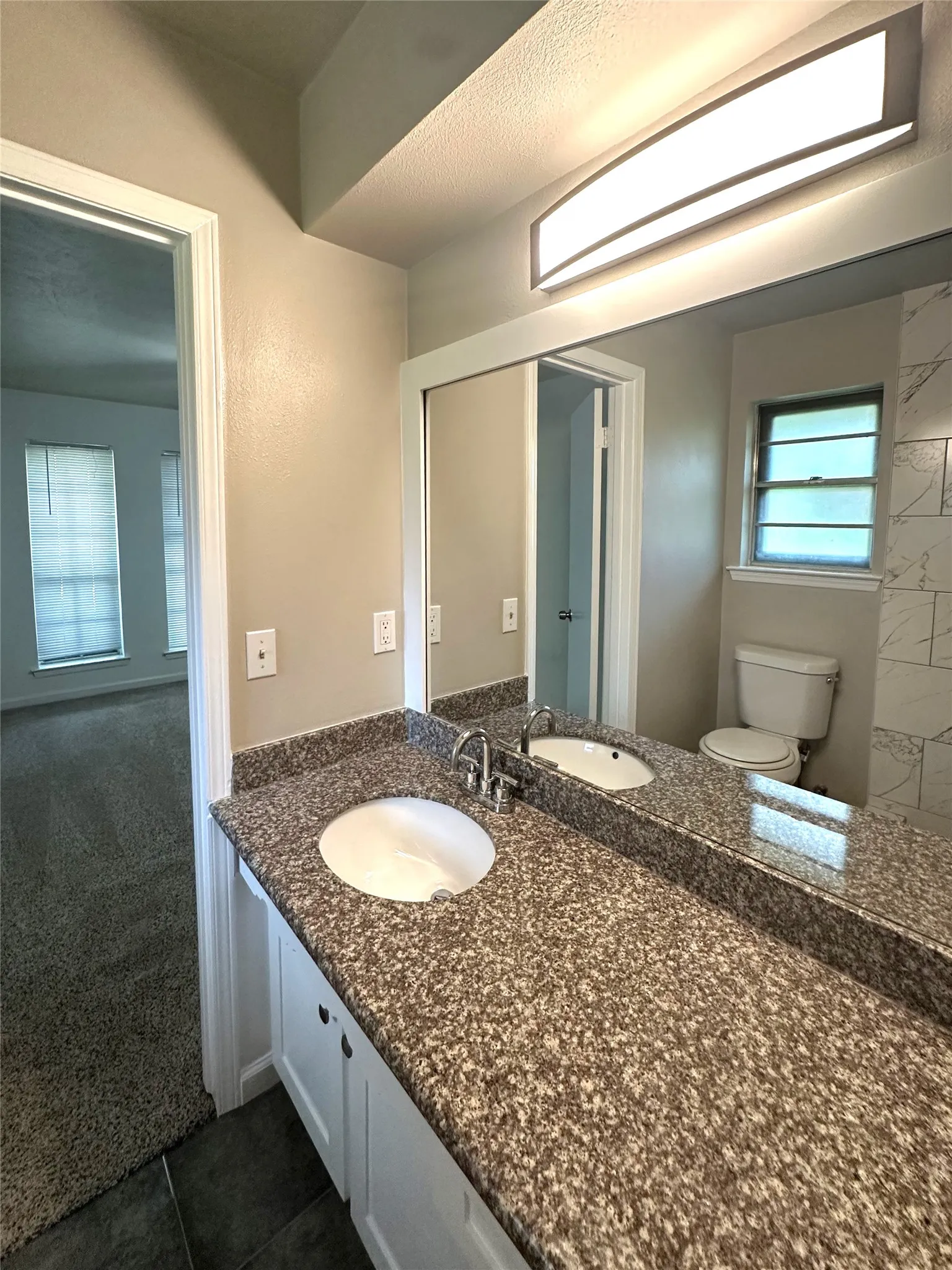 Dual vanity with integrated sinks and a speckled countertop