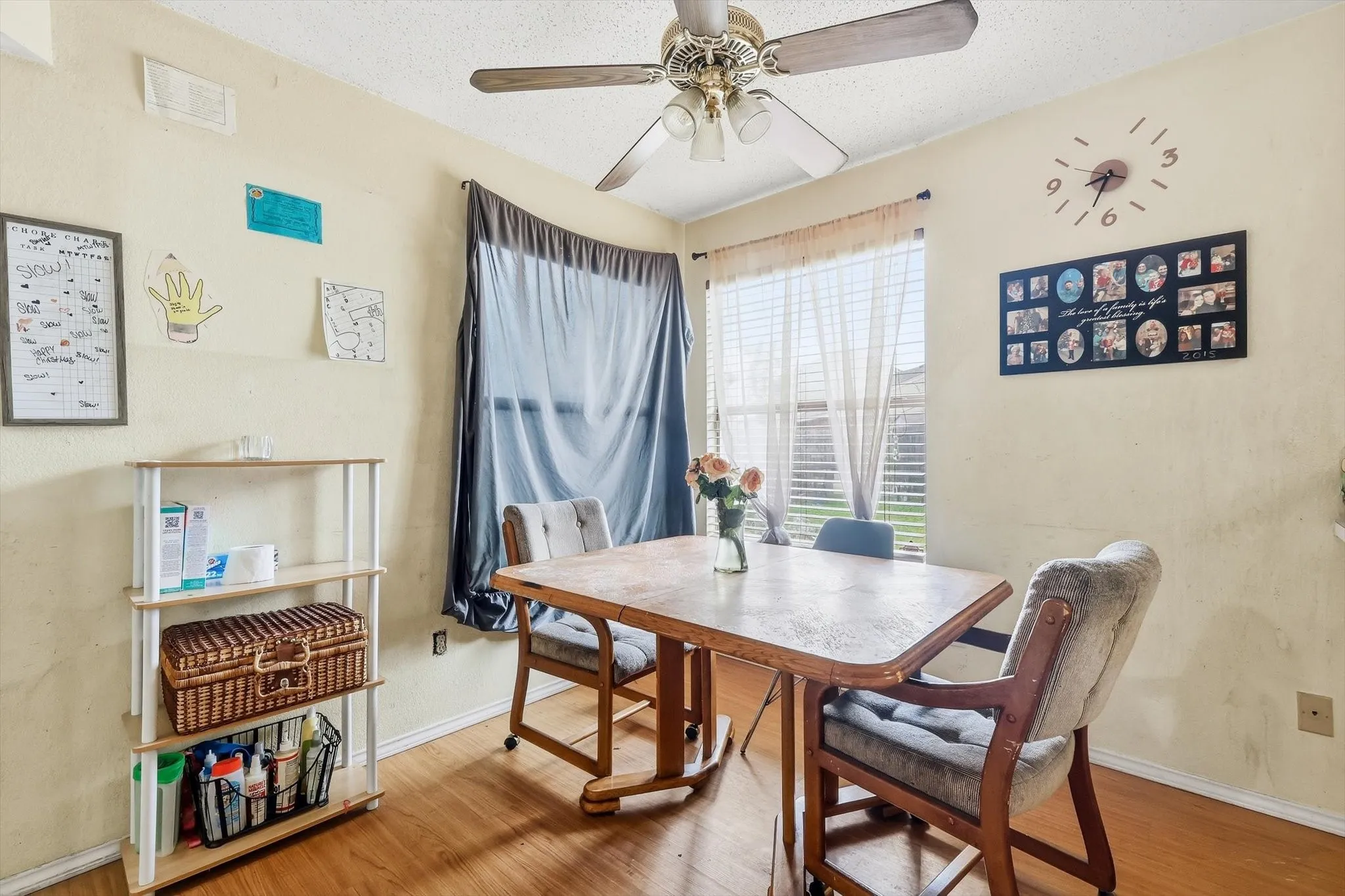 Dining area featuring wood-look flooring and a ceiling fan with integrated lighting