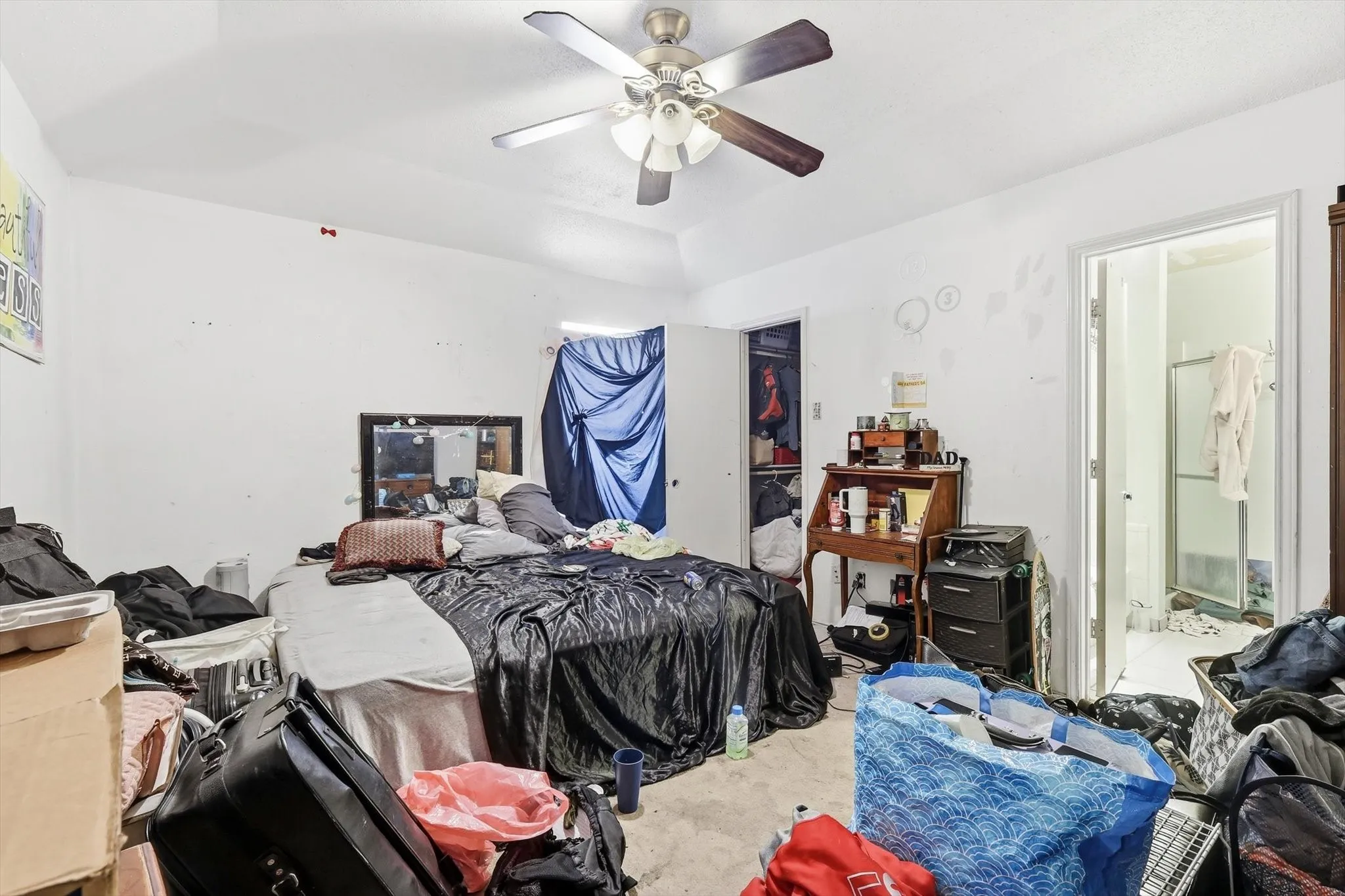 Primary bedroom with ceiling fan and ensuite bathroom