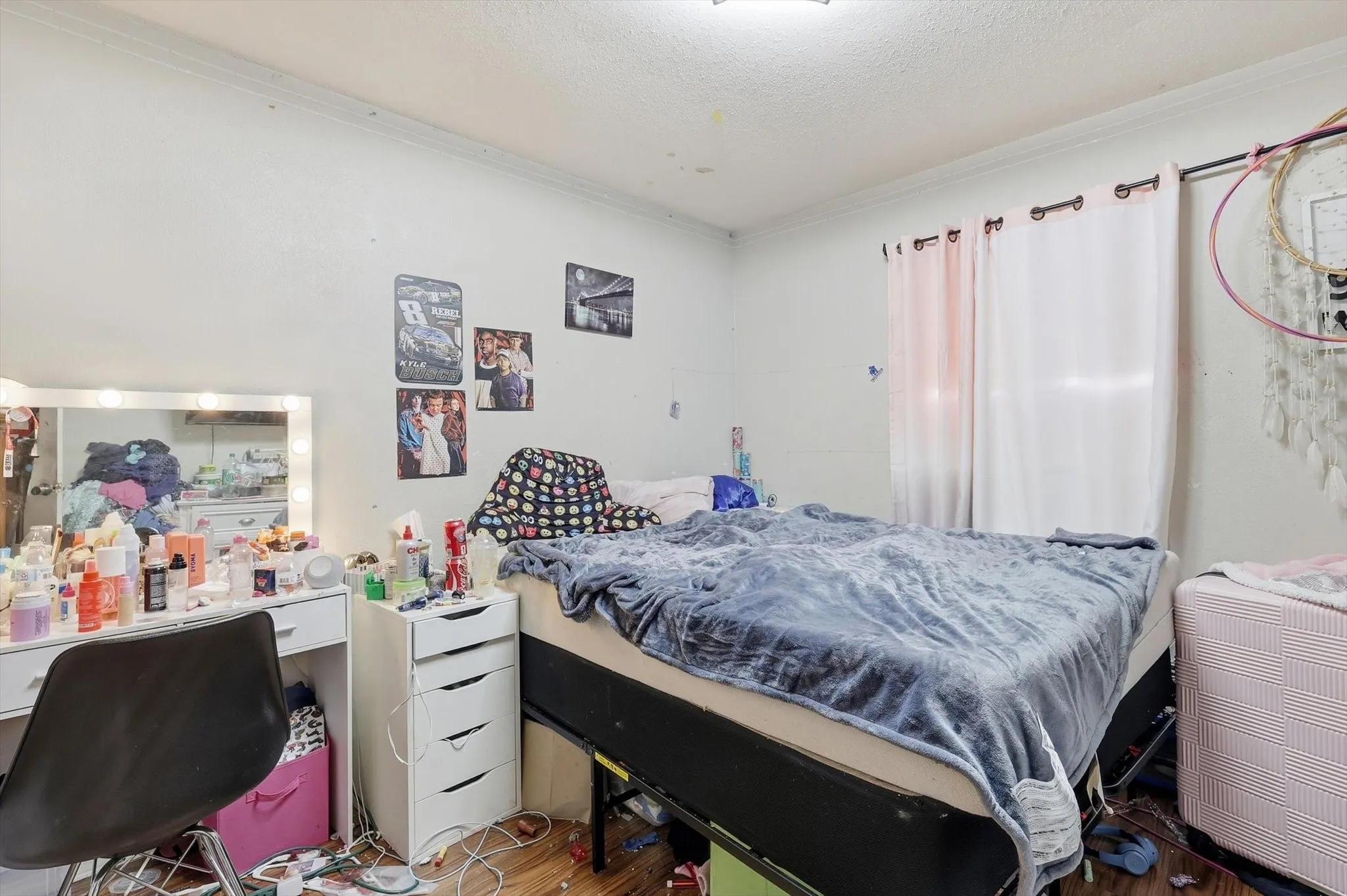 Room featuring light-colored walls and wood-look flooring