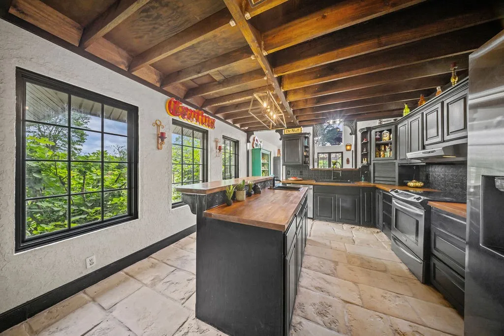 Stone flooring, butcher block counters and exposed beamed ceilings add lots of charm and architectural interest