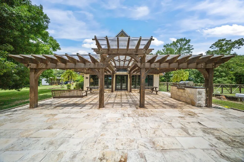 Amazing side patio with elegant pergola, grilling station and firepit with ample seating