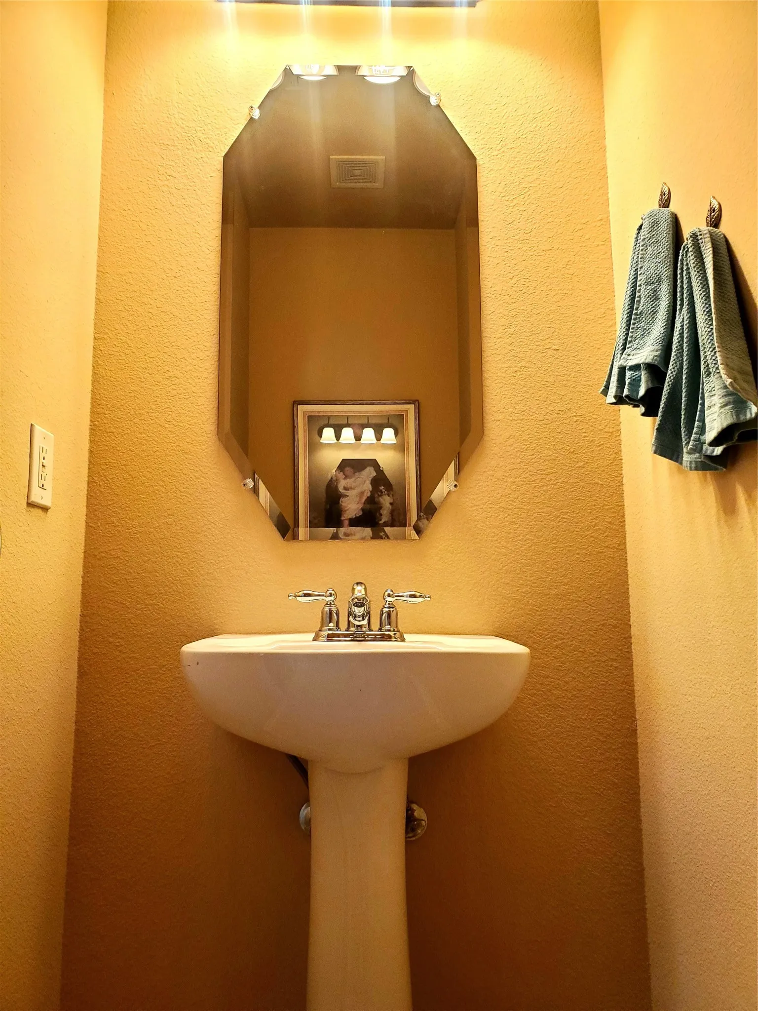 View of powder bathroom sink with tile floors