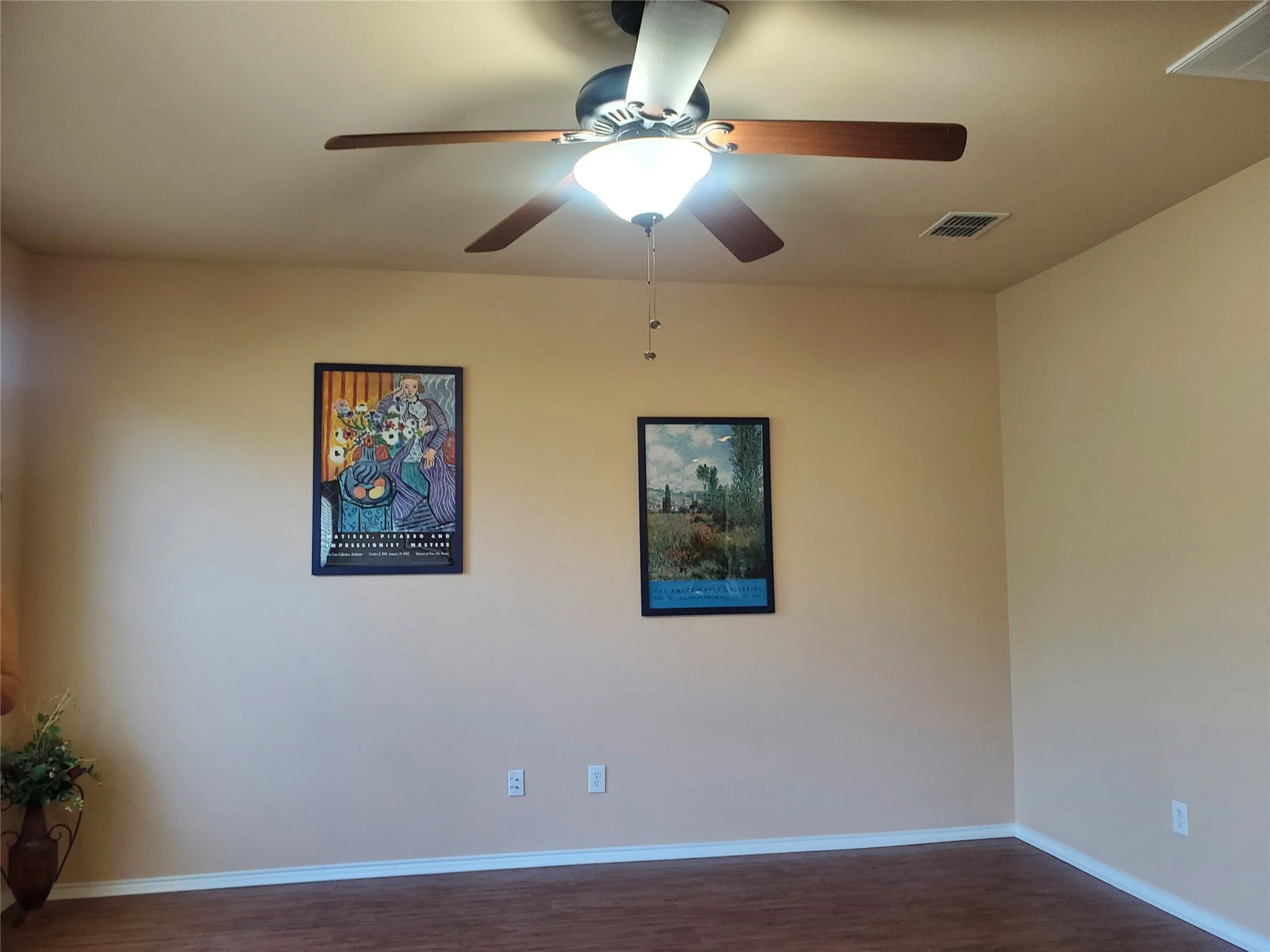 Living room featuring laminate flooring and ceiling fan