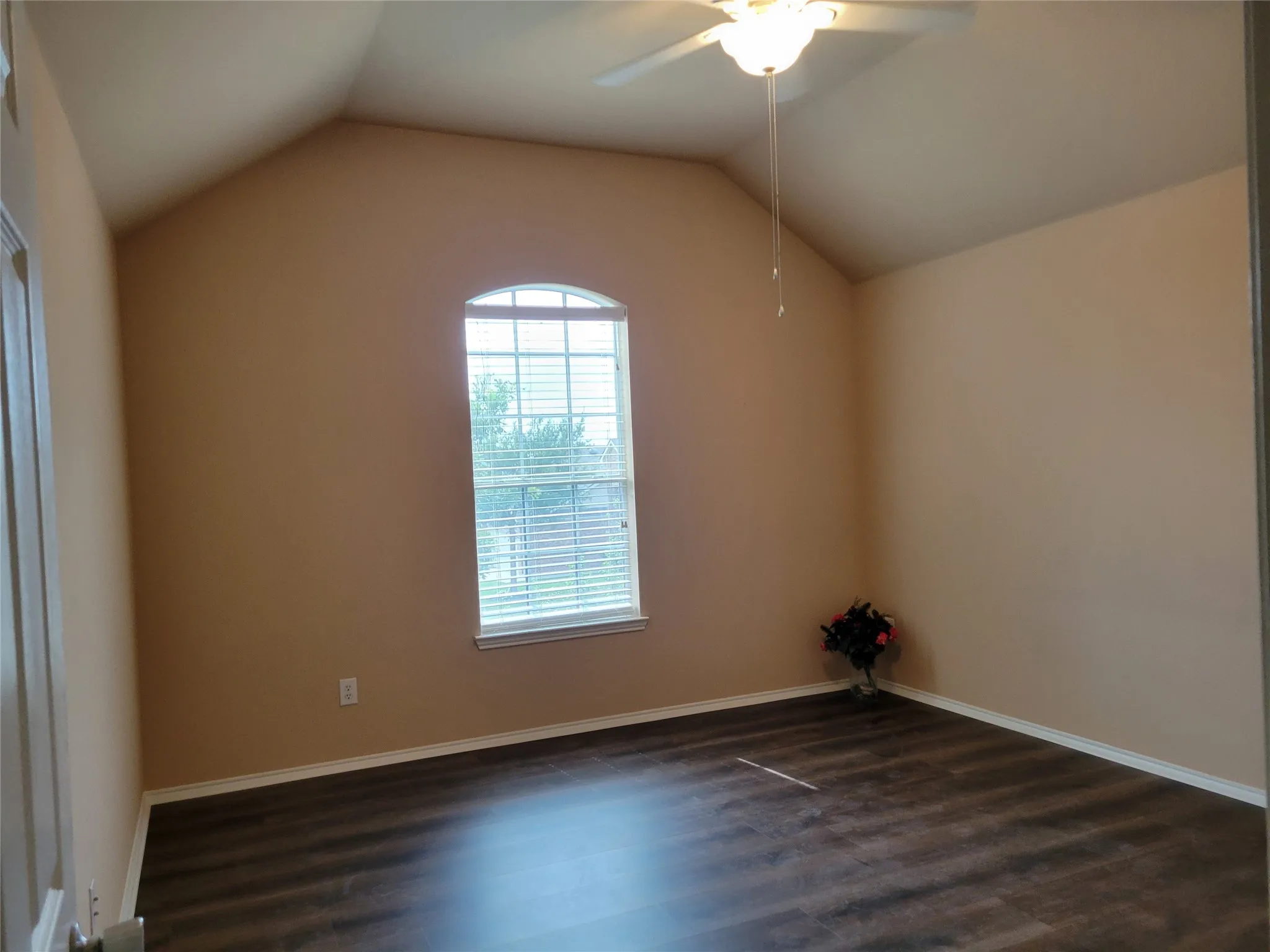 One of 3 bedrooms upstairs featuring laminate flooring, ceiling fan, walk-in closet, and plenty of natural light