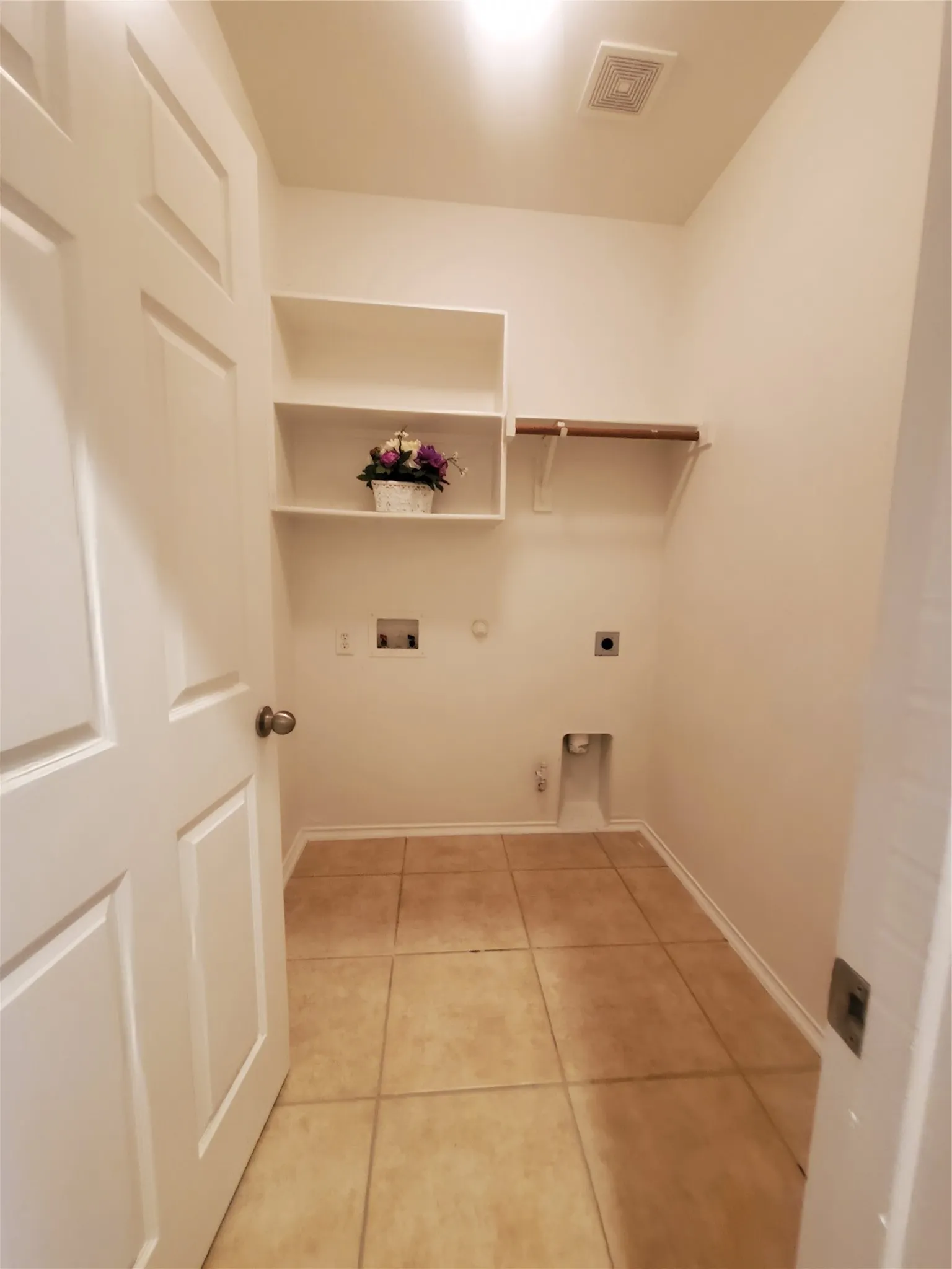 Washroom featuring hookup for a gas dryer, washer hookup, electric dryer hookup, and light tile floors