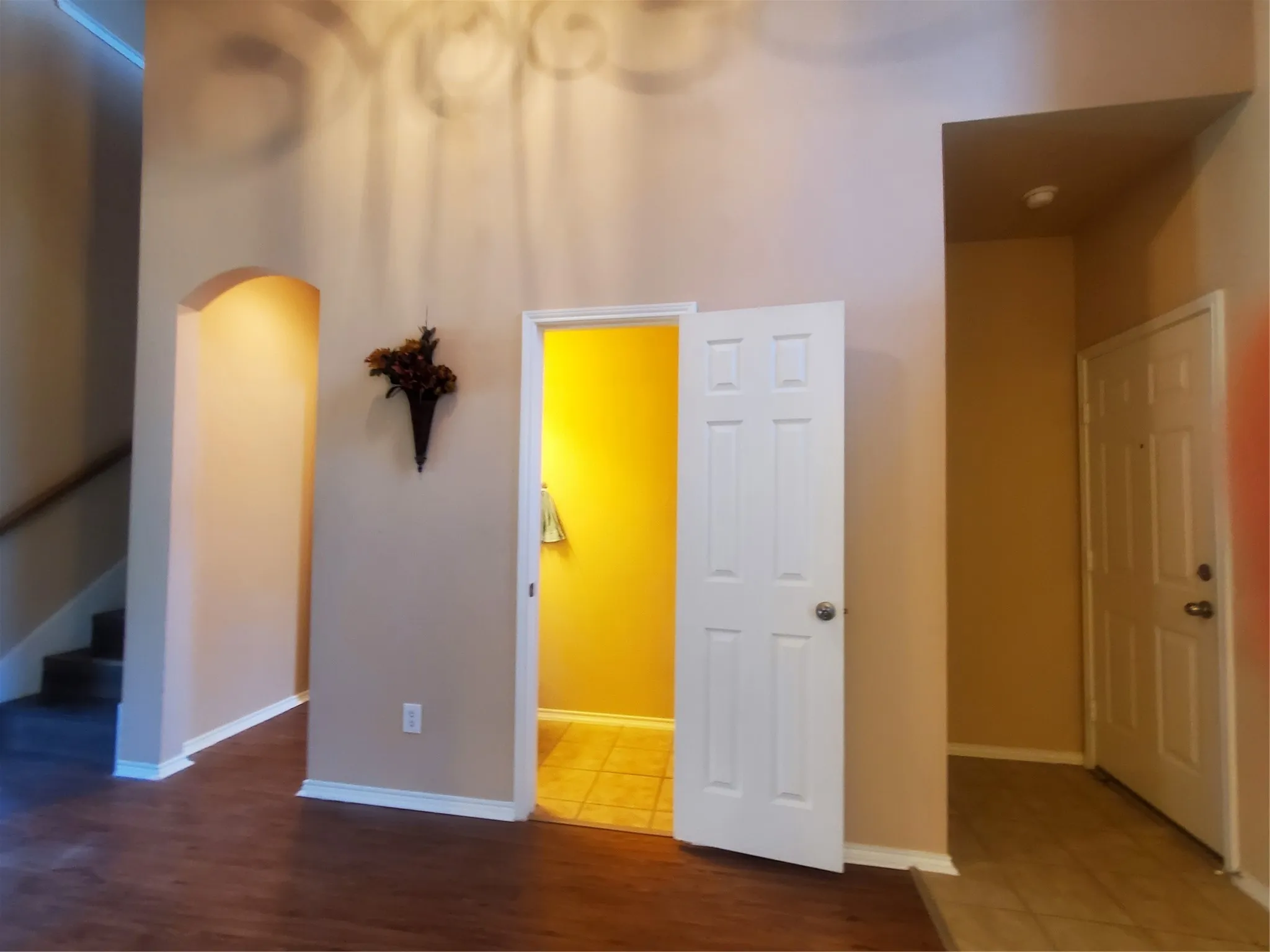 Entry is fairly wide with access to powder room, dining room, and garage.