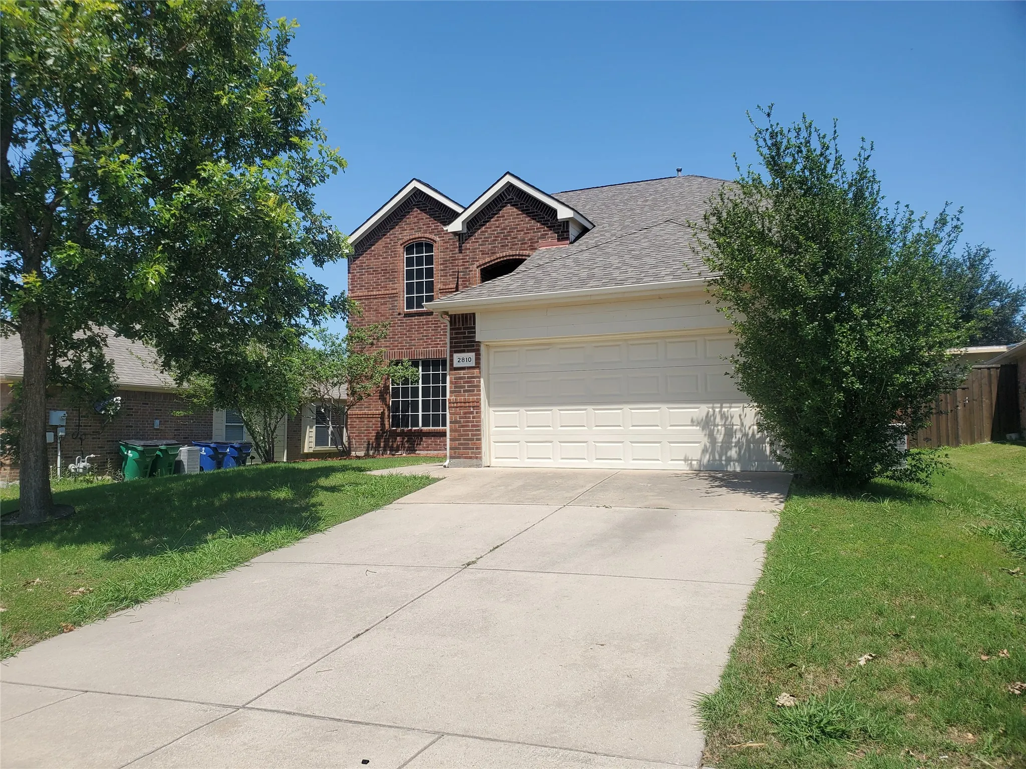 View of front of property featuring a garage and a front yard