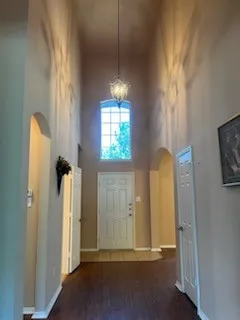 Foyer entrance with a high ceiling and laminate flooring