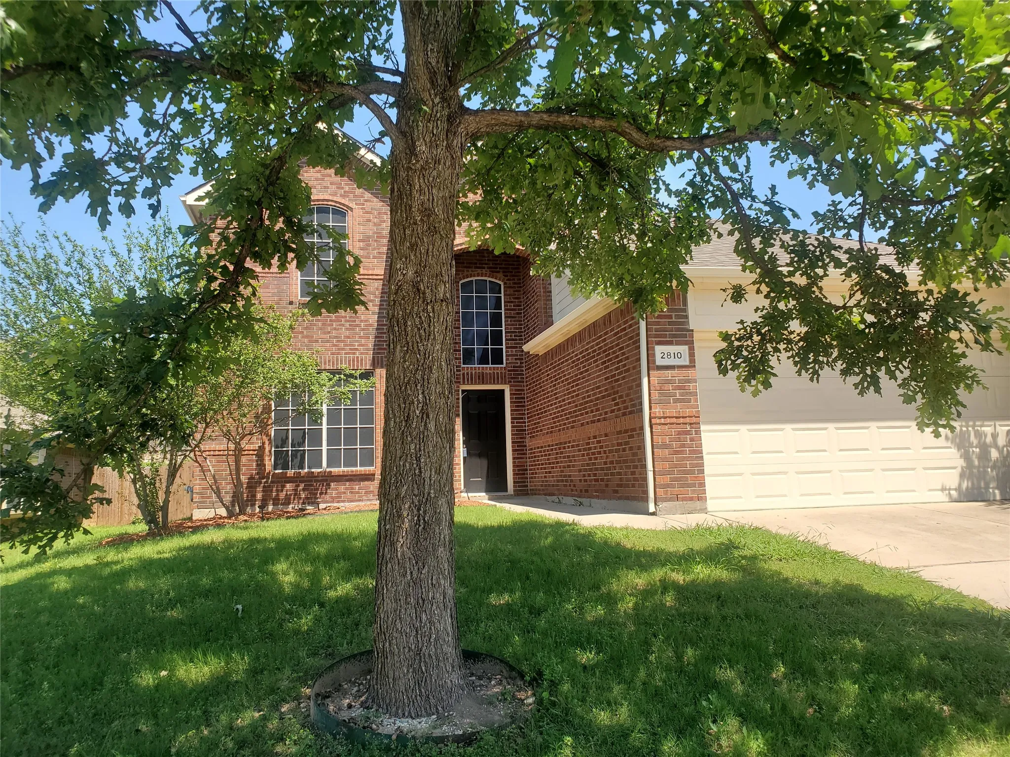View of front facade with a front yard and a garage