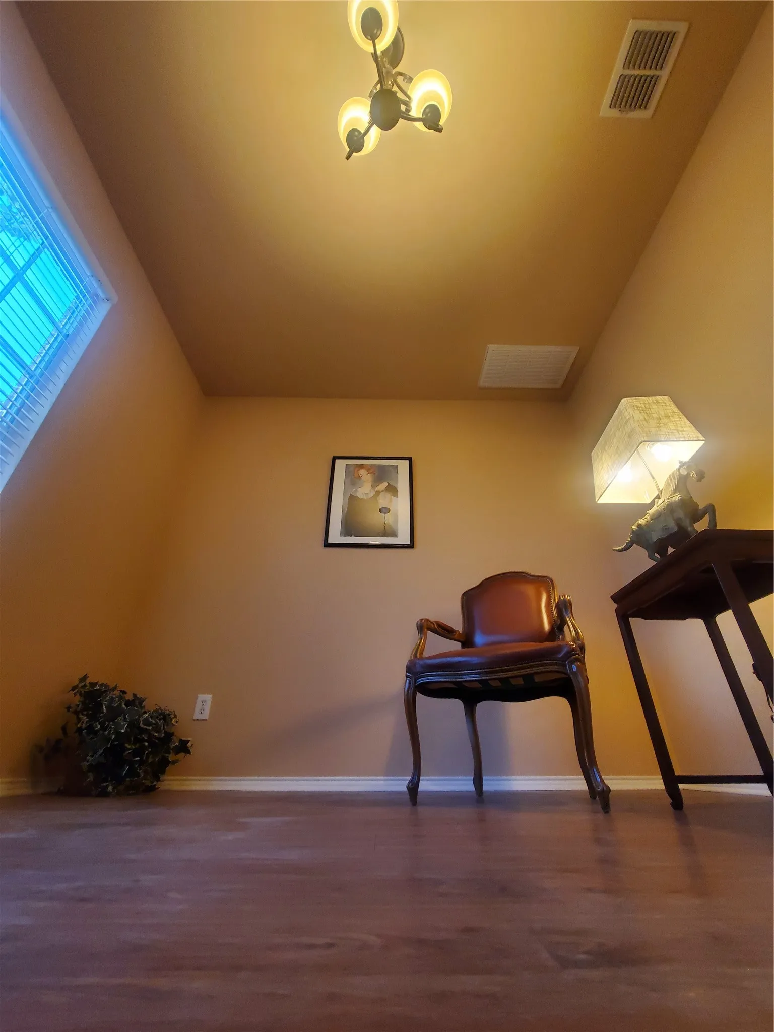 Dining room with a notable chandelier and laminate flooring