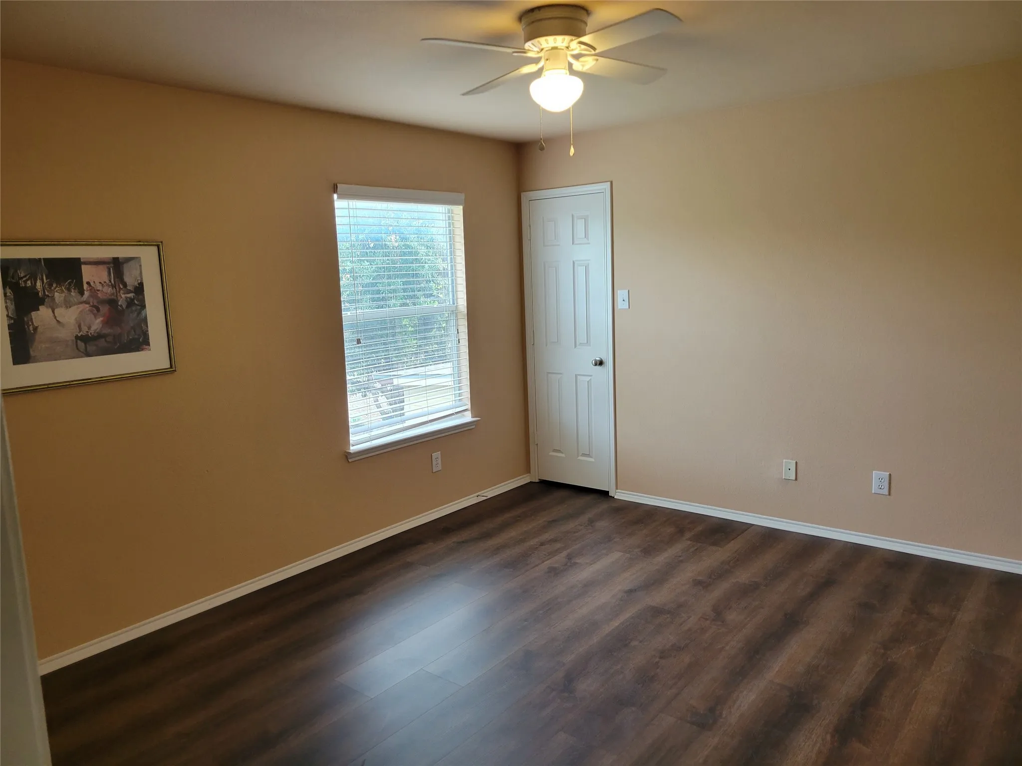 One of 3 bedrooms upstairs featuringlaminate flooring, ceiling fan, walk-in closet, and plenty of natural light