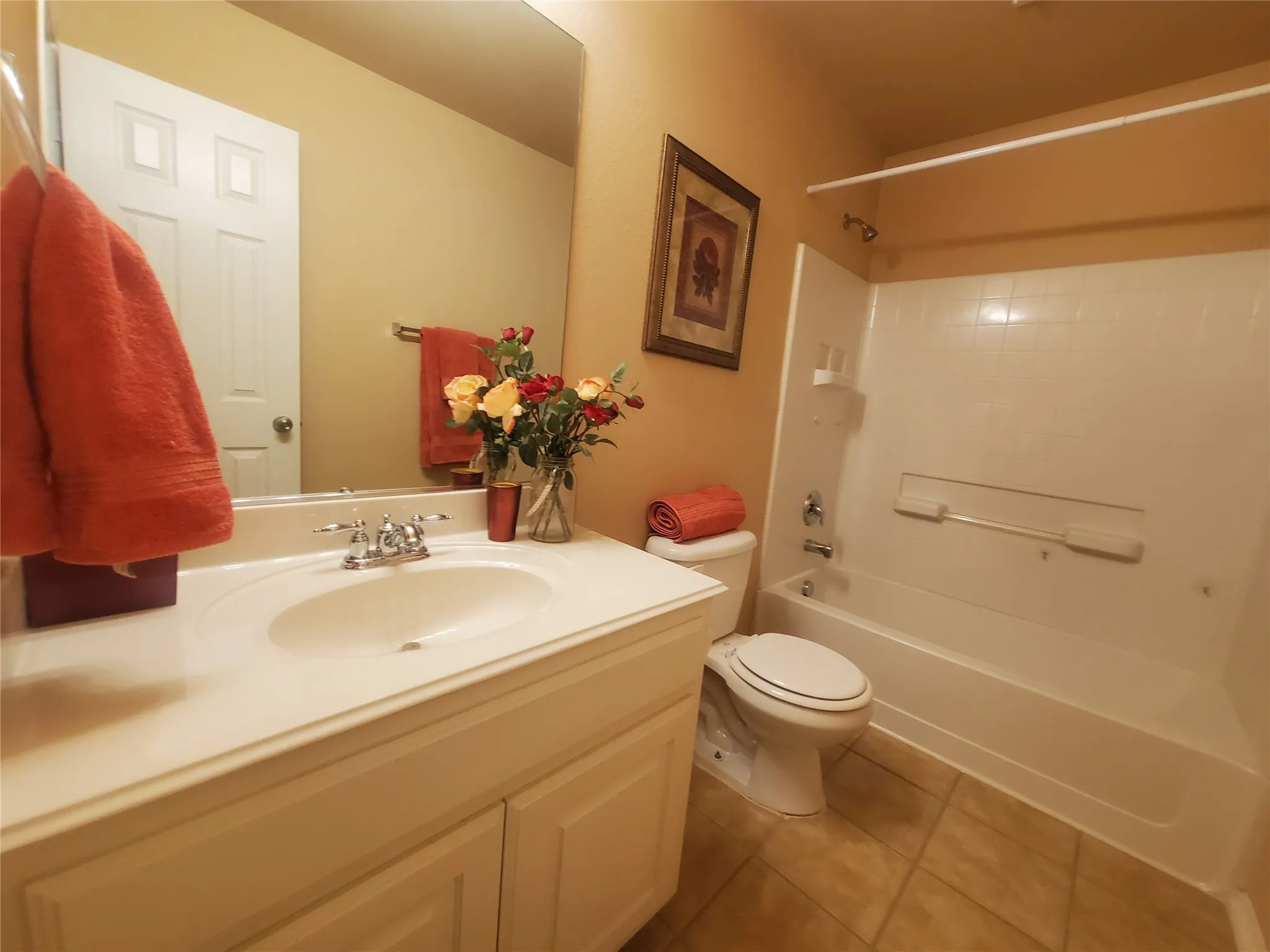 Full bathroom with tile floors, shower / bathing tub combination, toilet, and large vanity