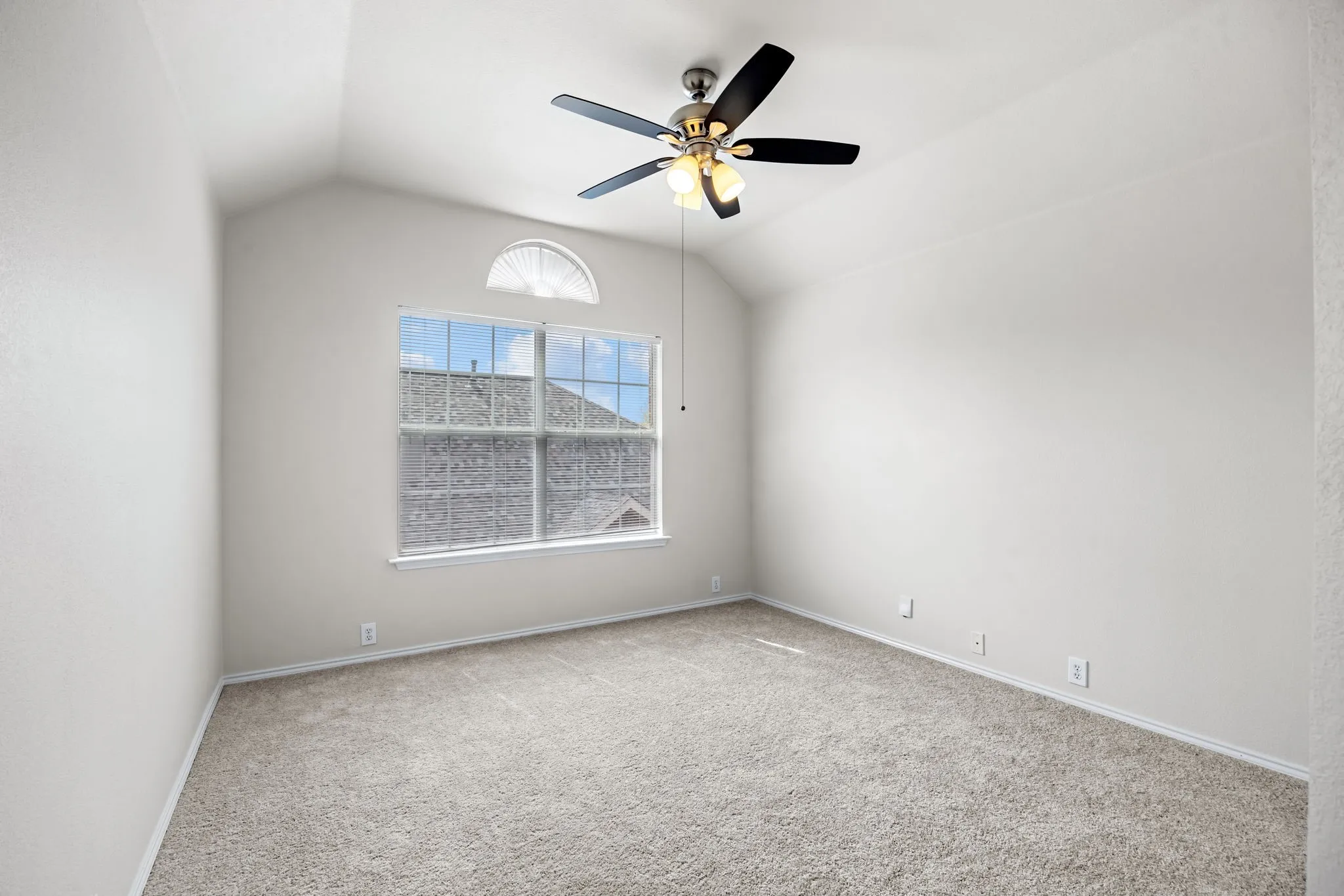 Empty room featuring carpet and ceiling fan