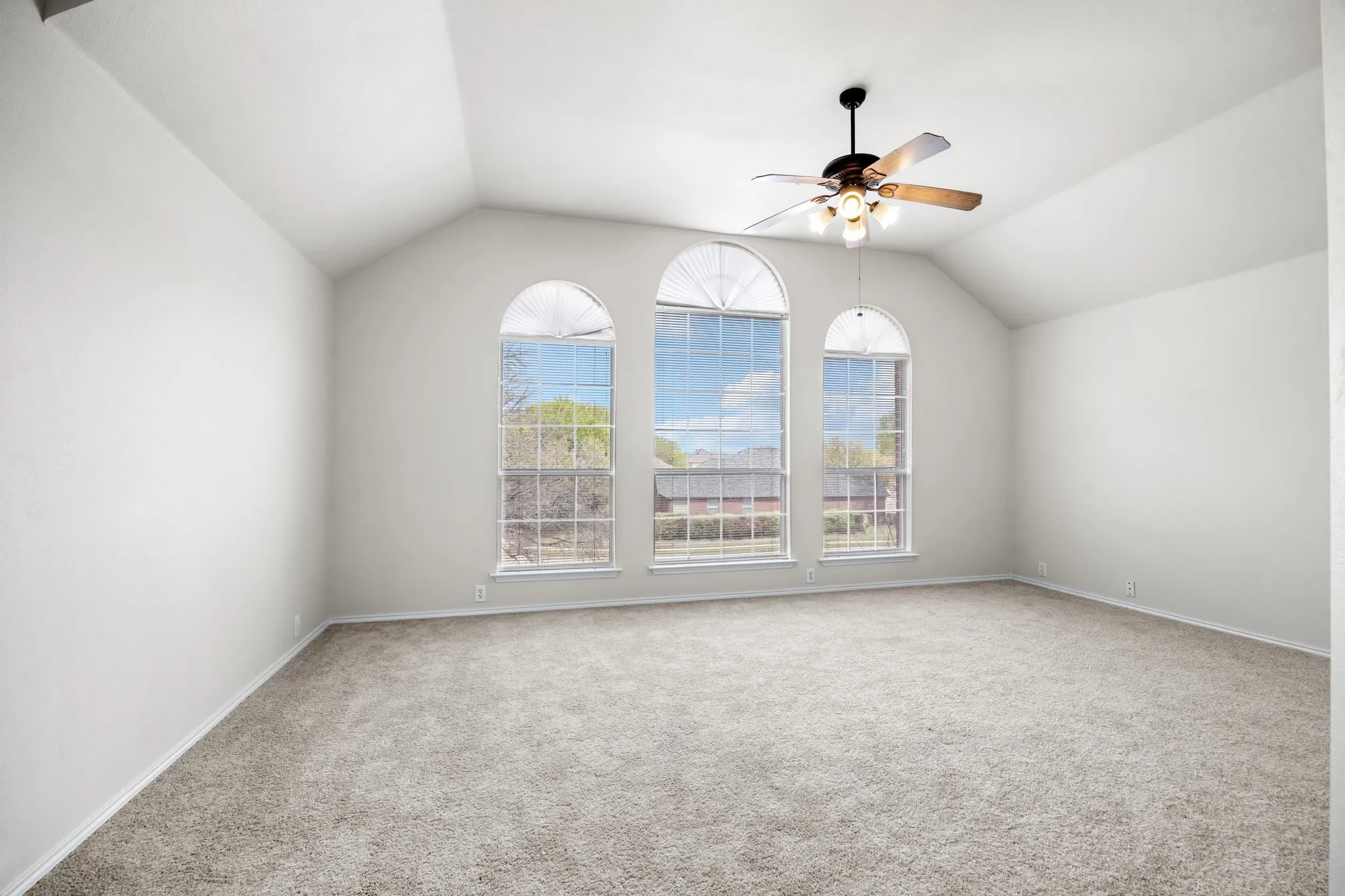 Spare room with carpet floors and ceiling fan