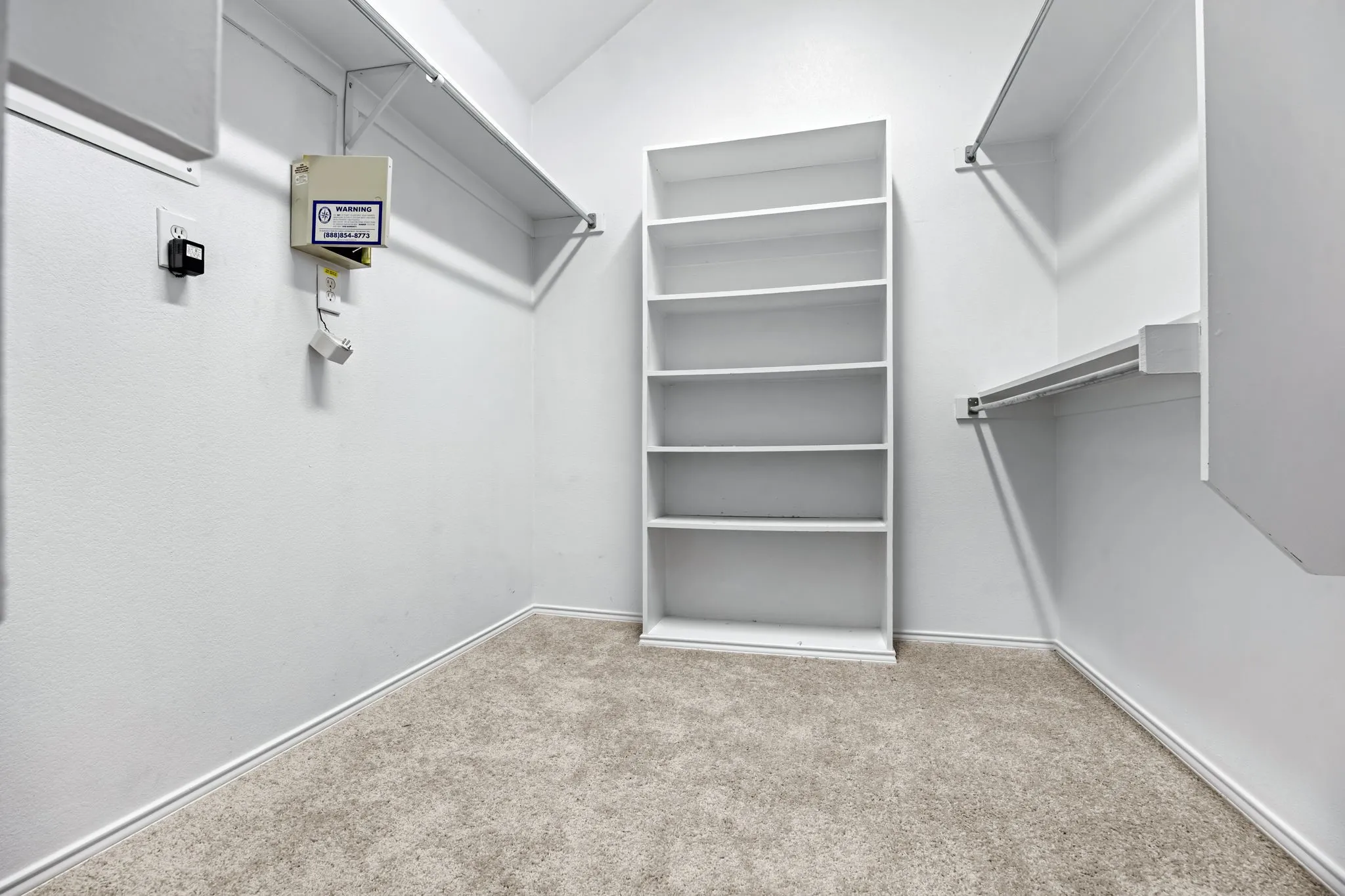 Walk in closet featuring light colored carpet