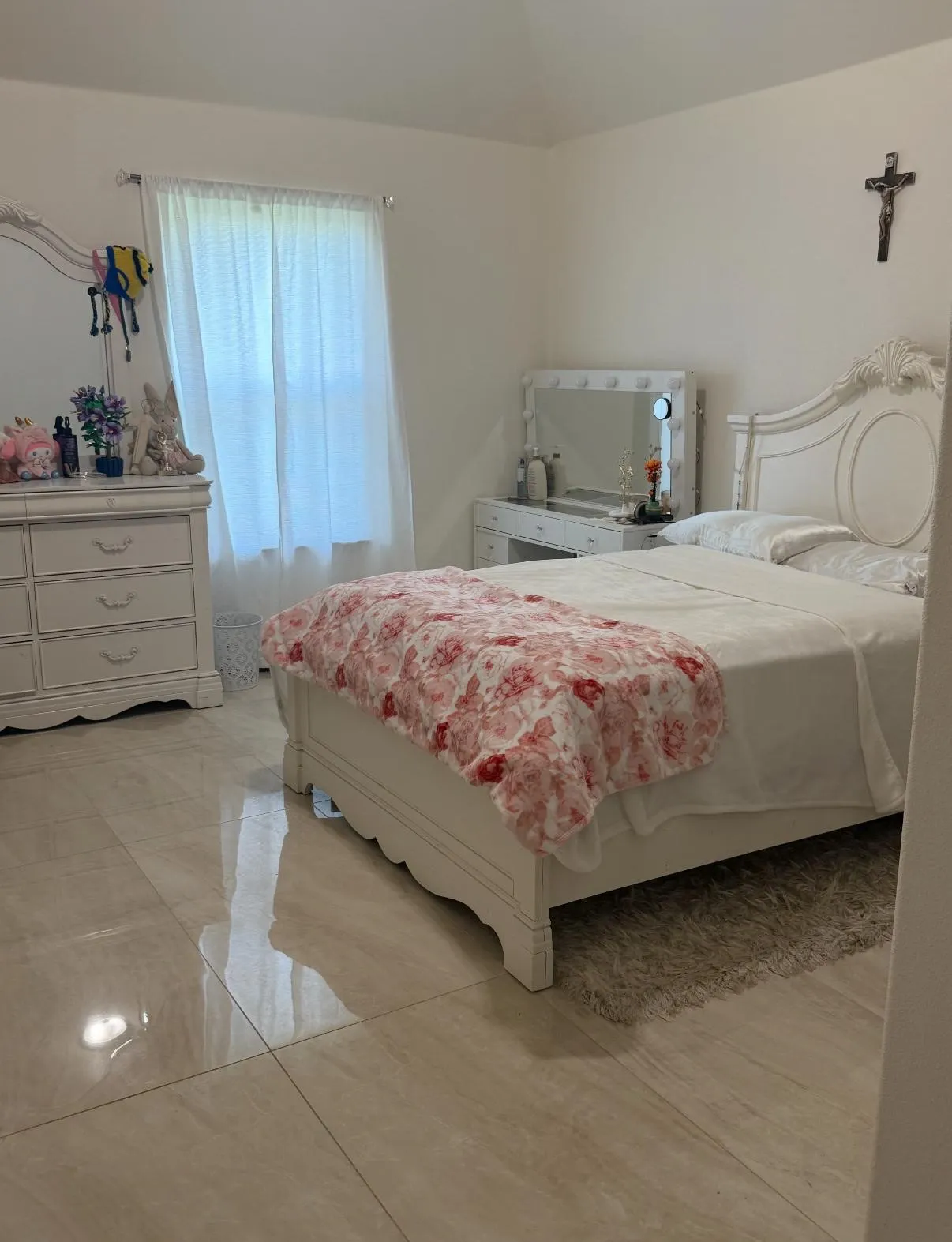 Room featuring tile flooring, a window with sheer white curtains, and vaulted ceilings