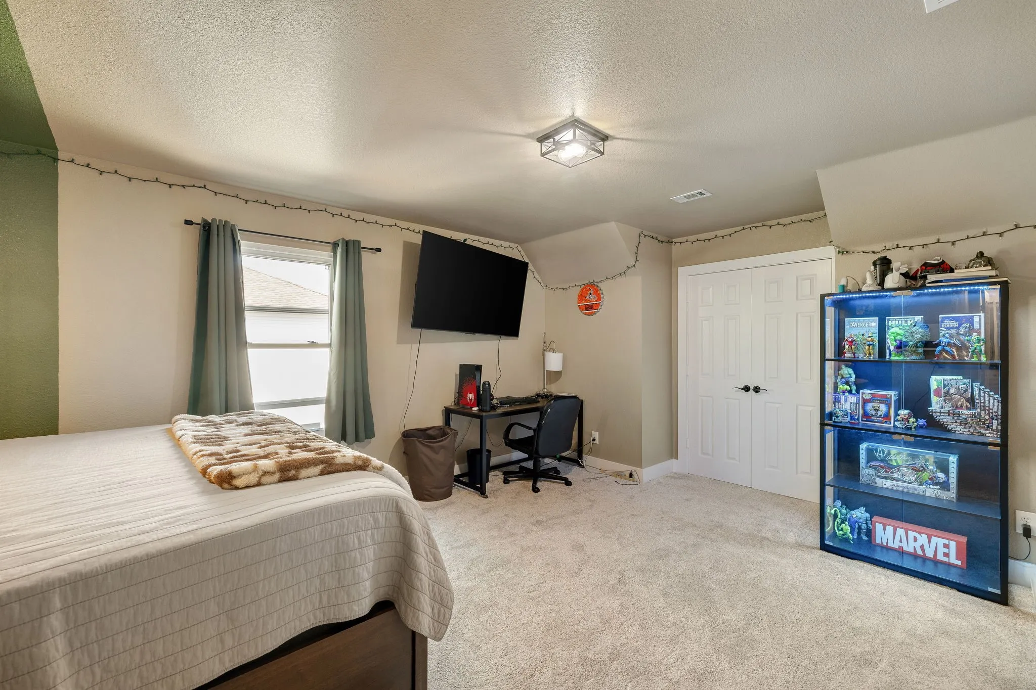 Carpeted room featuring a double-door closet, two windows with drapes, and a flush mount ceiling light fixture