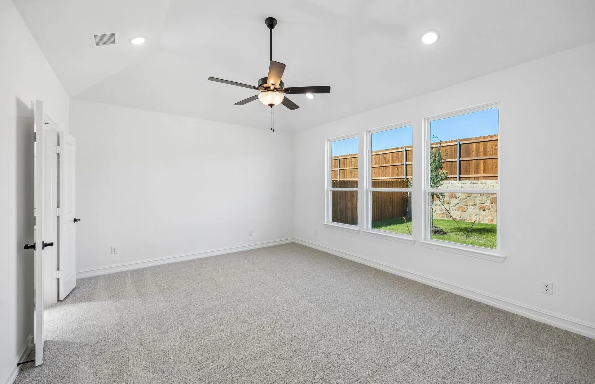 Primary bedroom with large windows