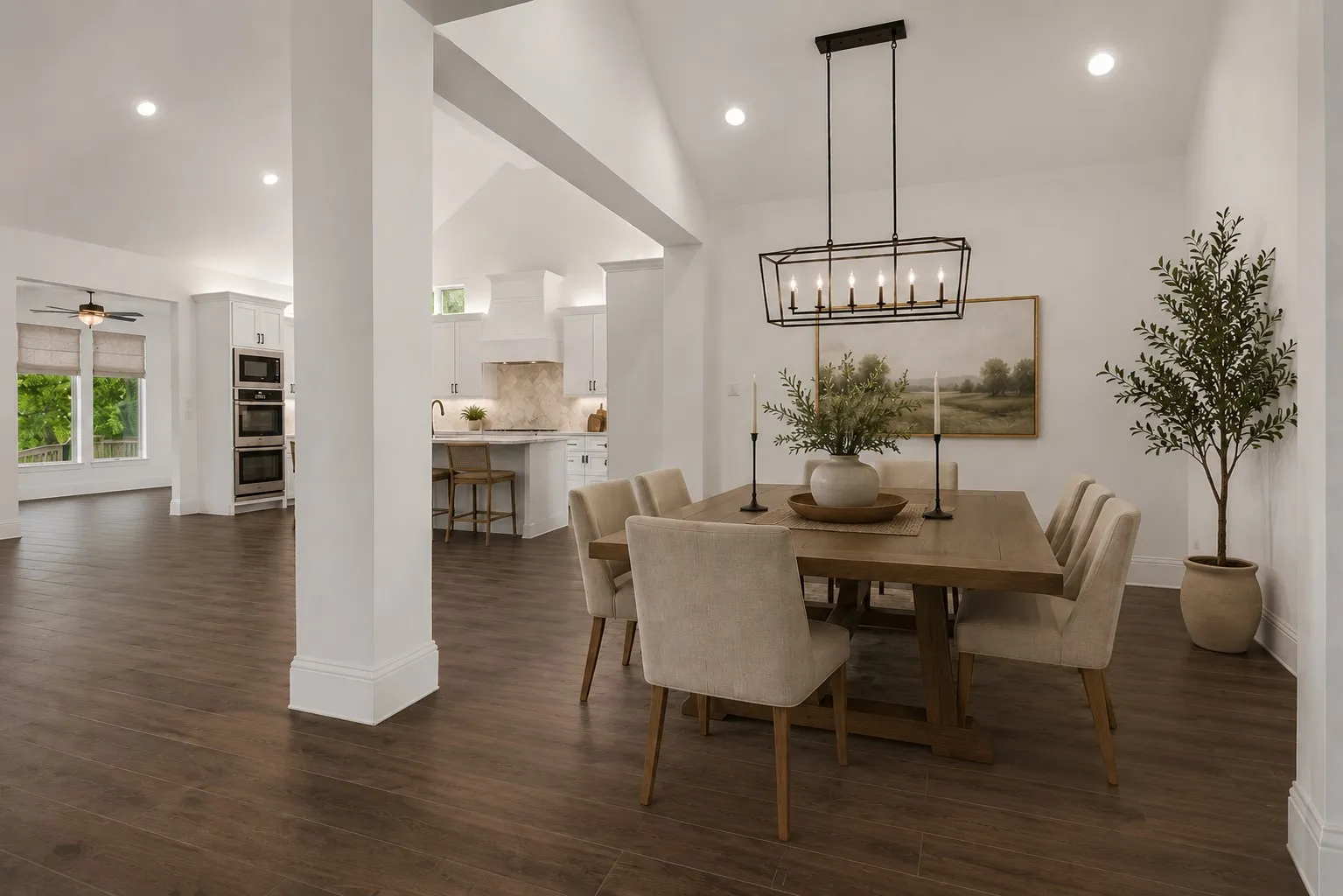 An oversized flex space offers endless possibilities for a formal dining room, game room, home office, fitness studio, or second living area—beautifully connected to the kitchen and main entertaining spaces. (Ai Staged - no chandelier)