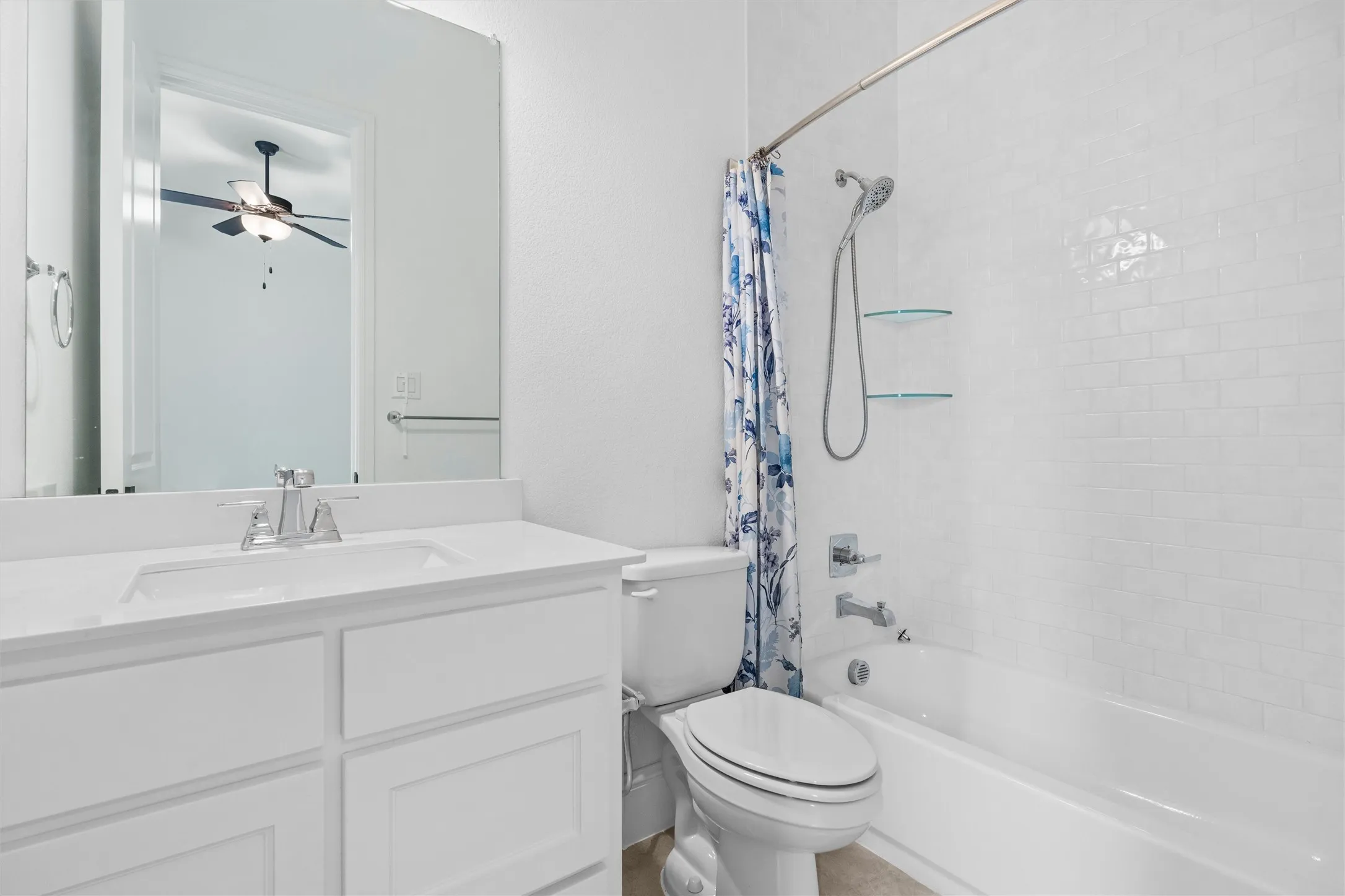 A beautifully finished full bath with a bright white vanity, classic subway-tile tub and shower, and clean, timeless details that make daily routines feel effortless.