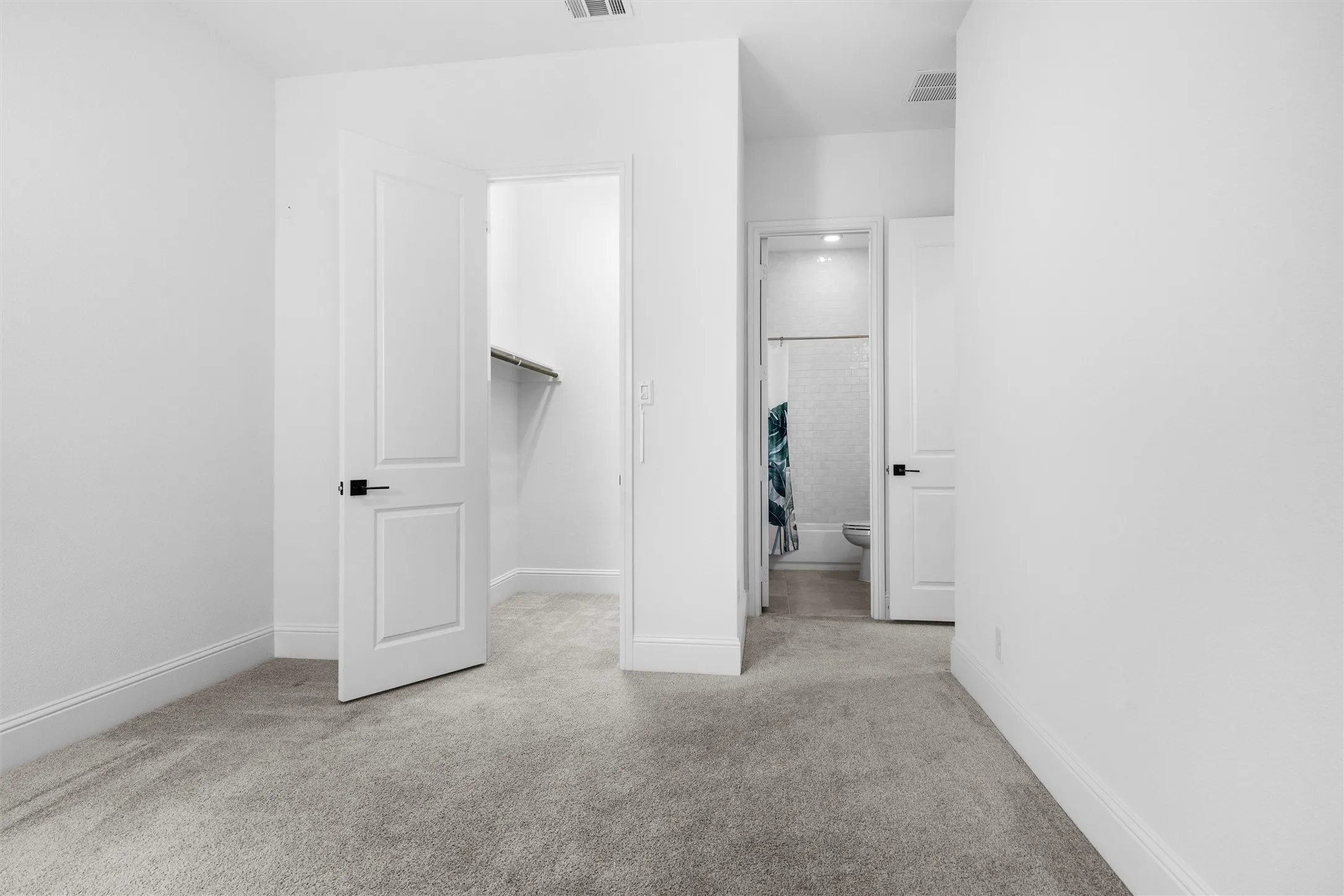 A thoughtfully designed bedroom layout provides easy access to a nearby closet and full bathroom, making it ideal for family, guests, or a private teen retreat.