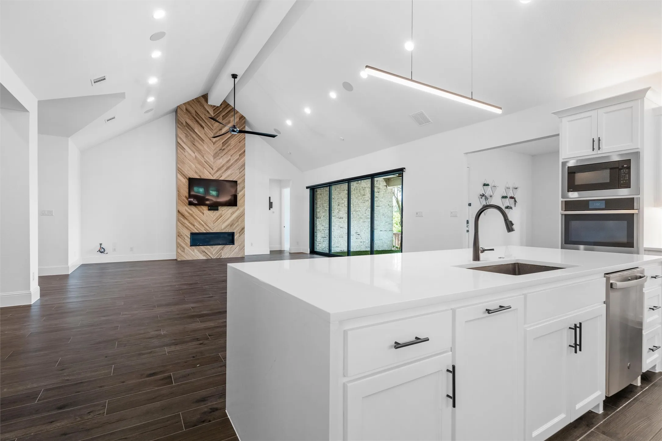 The kitchen opens effortlessly into the main living area, creating one bright, connected space where cooking, entertaining, and relaxing all happen together. The massive island gives everyone a front-row seat to the action.