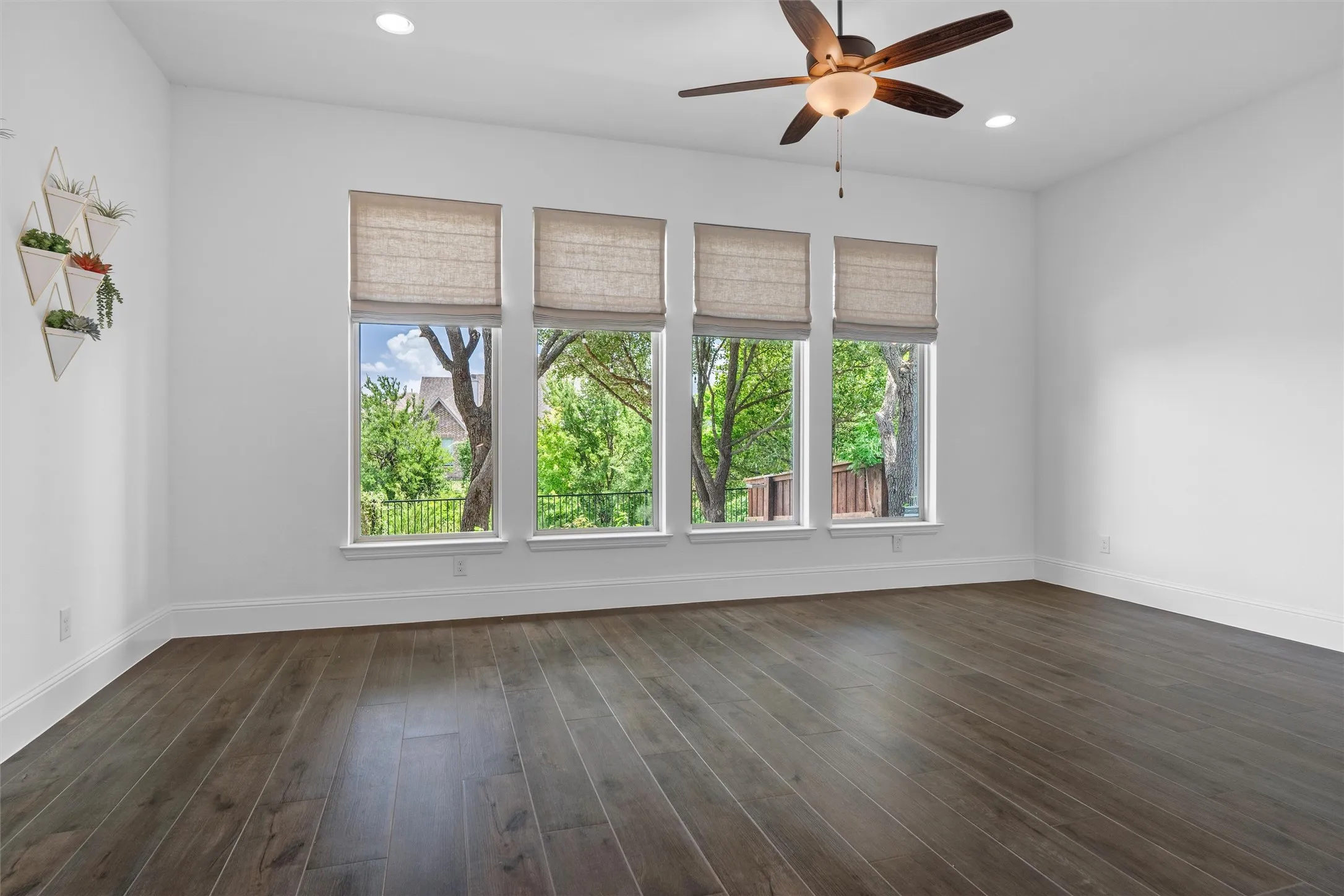 This bright front flex room is ready to become your dream home office, formal sitting area, reading lounge, or creative studio, with tall windows, soft natural light, and a welcoming view of the entry.