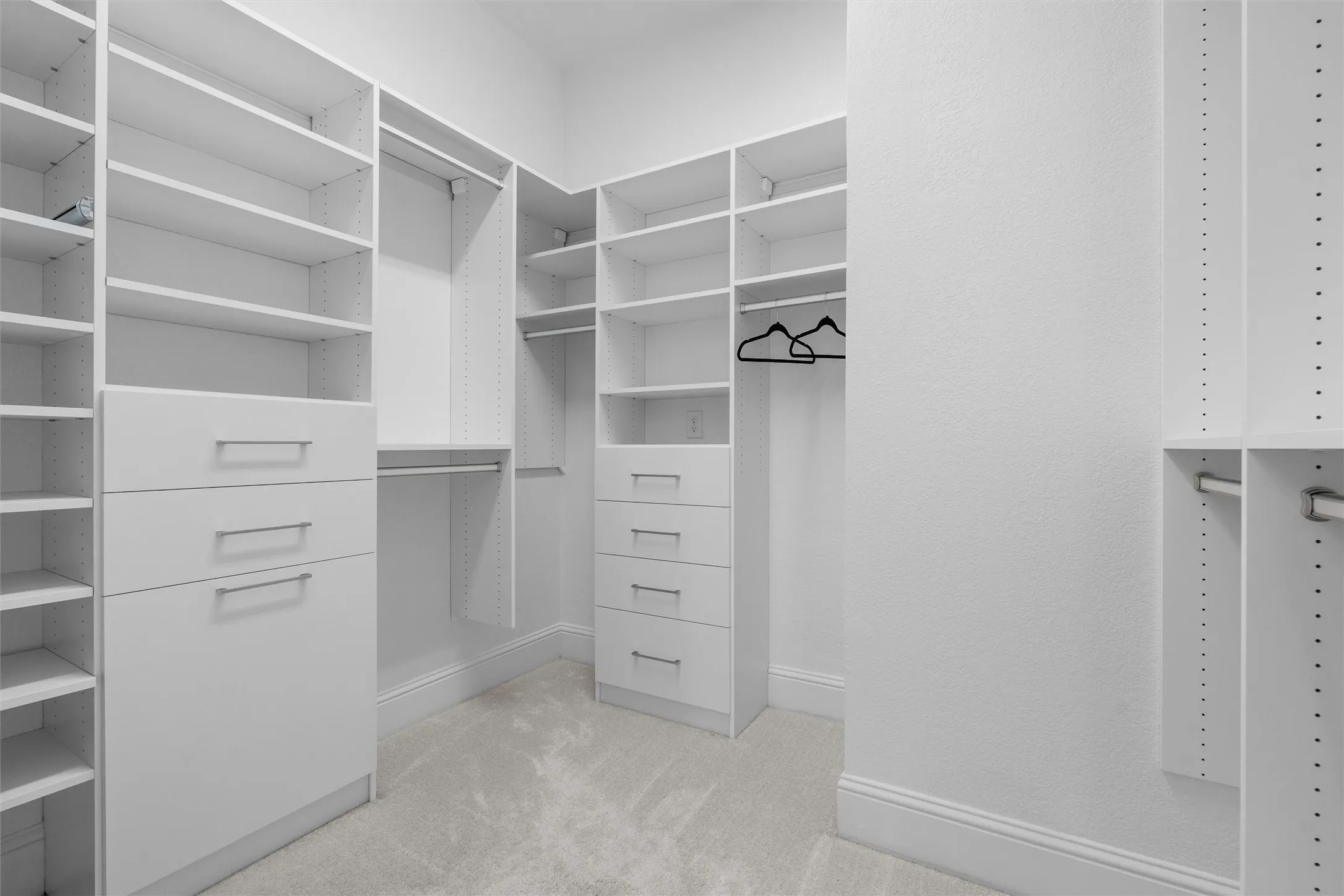 This oversized custom closet provides the organization every homeowner dreams about, with extensive adjustable shelving, built-in drawers, hanging space, and room for a complete wardrobe collection.